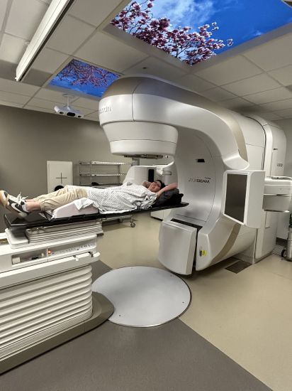 Dani Kurtz lies under a Varian TrueBeam linear accelerator in an undated photo.