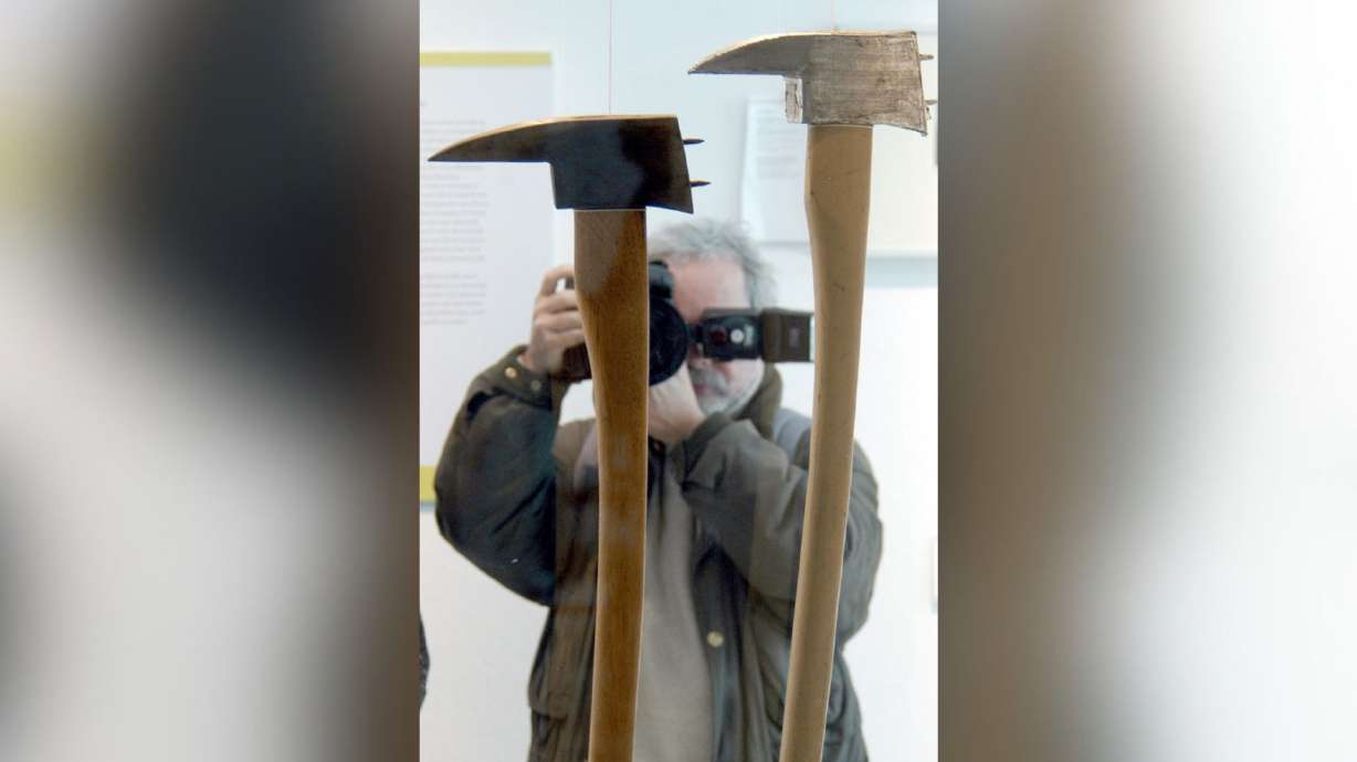 A photographer takes pictures of axes used in the movie "The Shining, " which were part of a joint exhibition of the German Film Museum and the German Architectural Museum in Frankfurt, Germany, Tuesday, March 30, 2004. Stanley Kubrick's personal archive is up for auction. Highlights include the axe wielded by Jack Nicholson in "The Shining" and the prop infant from "2001: A Space Odyssey."