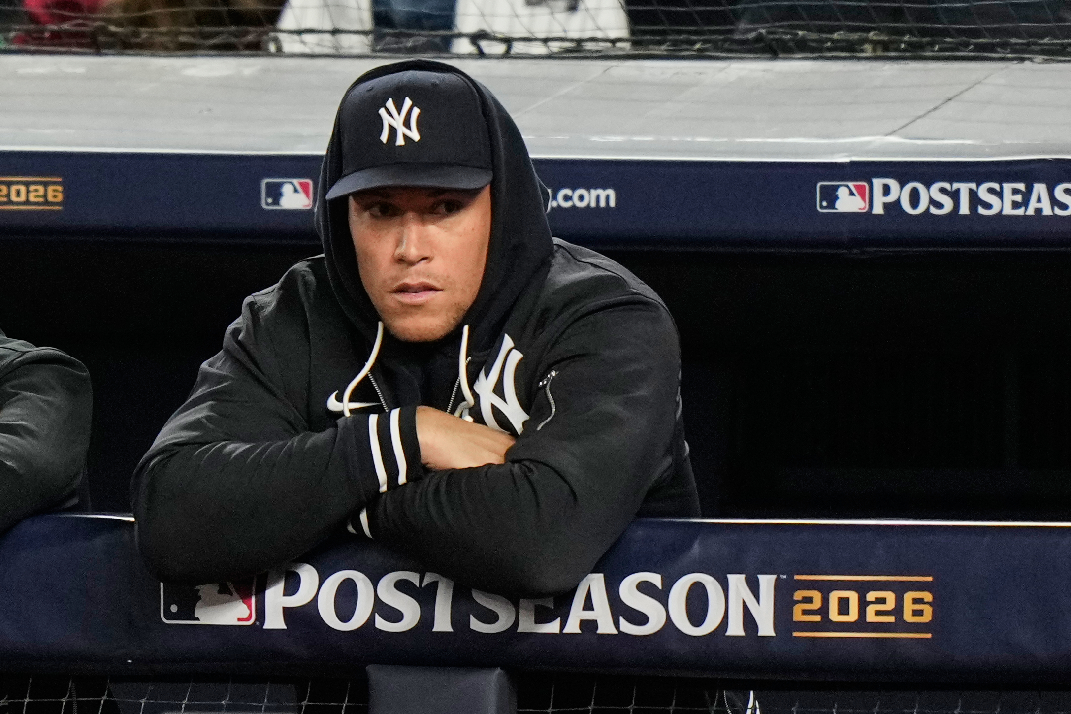 New York Yankees' Aaron Judge stands in the dugout watching play against the Tampa Bay Rays during the second inning in Game 3 of baseball's American League Division Series, Wednesday, Oct. 7, 2026, in New York. 
