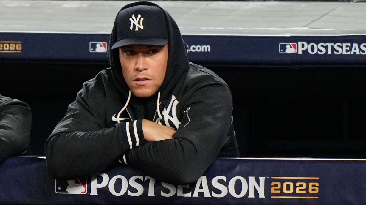 New York Yankees' Aaron Judge stands in the dugout watching play against the Tampa Bay Rays during the second inning in Game 3 of baseball's American League Division Series, Wednesday, Oct. 7, 2026, in New York.