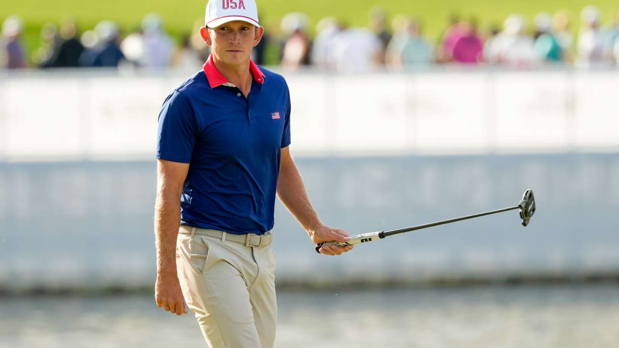 USA teams' Jacob Bridgeman watches his shot on the 13th green against the International team during a Presidents Cup golf tournament third round foursome match at Medinah Country Club, Saturday, Sept. 26, 2026, in Medinah, Ill.