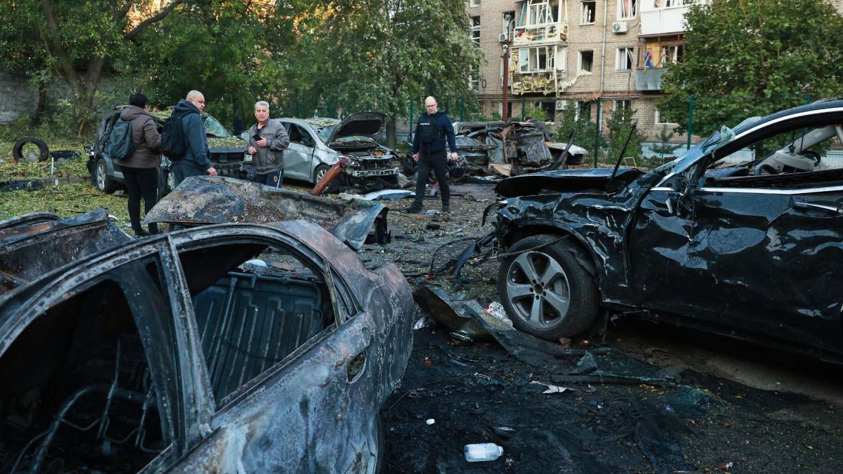 Cars are seen damaged by a Russian strike on residential neighborhood in Zaporizhzhia, Ukraine, Friday. The strikes killed three people and wounded at least eight.