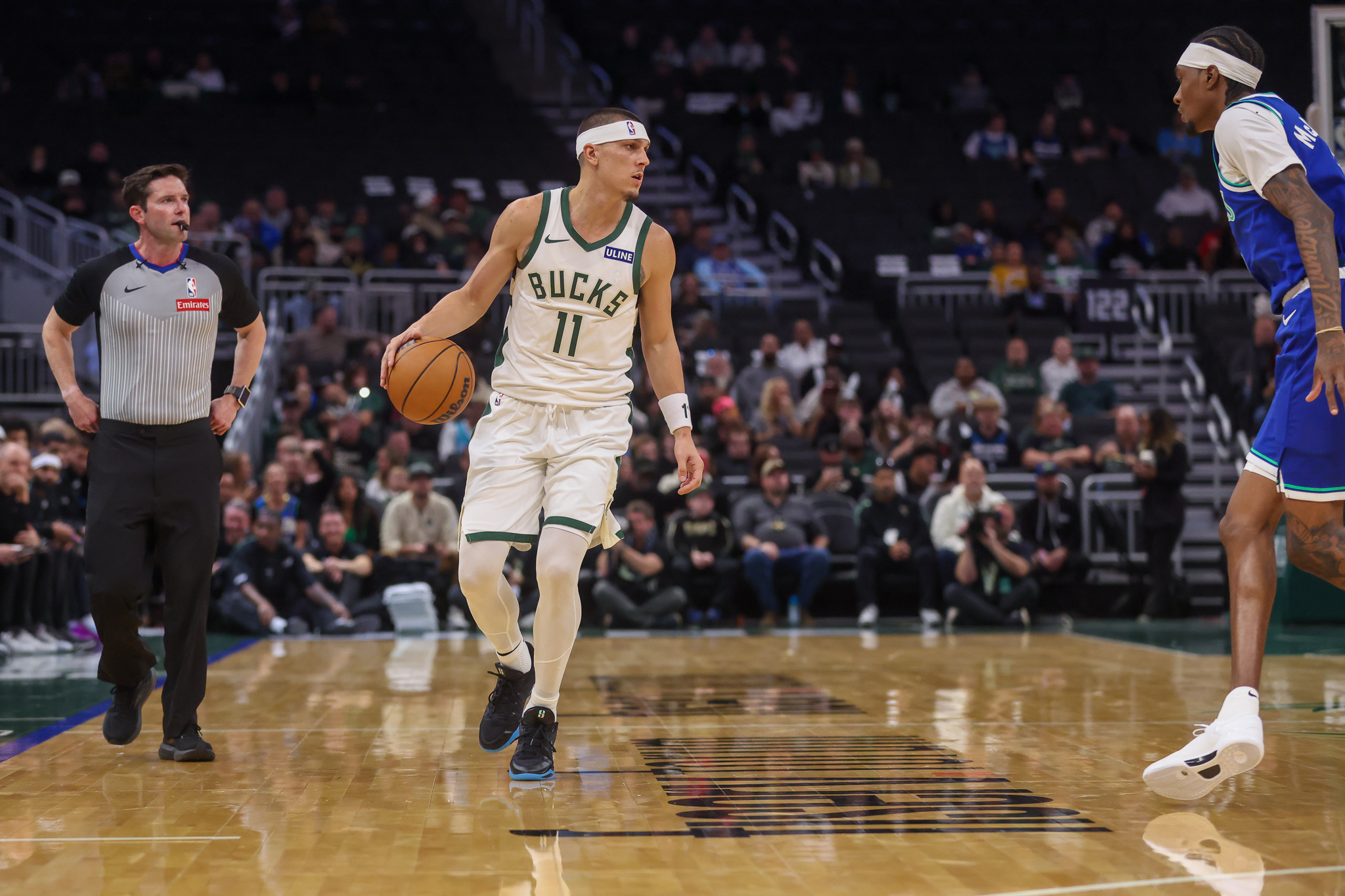 Milwaukee Bucks' guard Tyler Herro, left, brings the ball up the court against Minnesota Timberwolves forward Jaden McDaniels', right, during a preseason NBA basketball game Monday, Oct. 5, 2026, in Milwaukee. 