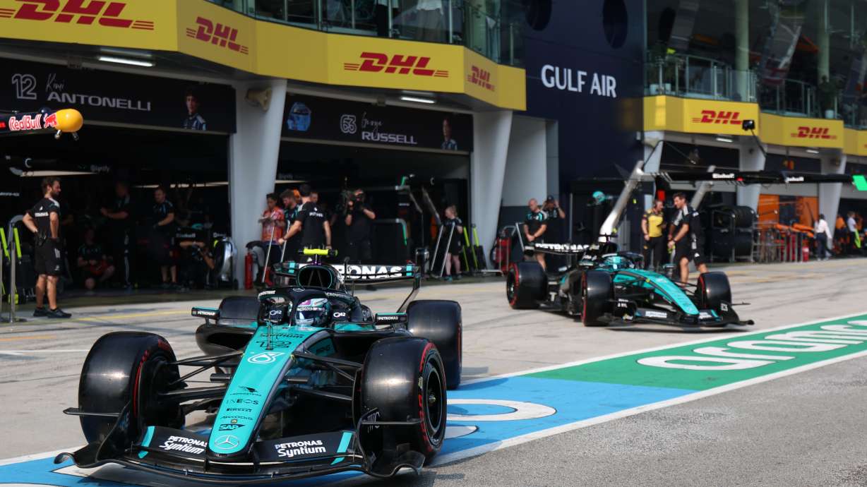 Mercedes driver Andrea Kimi Antonelli of Italy, left, and his teammate George Russell of Britain steer their cars out from the garage during the qualifying session for the Bahrain Grand Prix in Sepang, Malaysia, Saturday, Oct. 3, 2026.