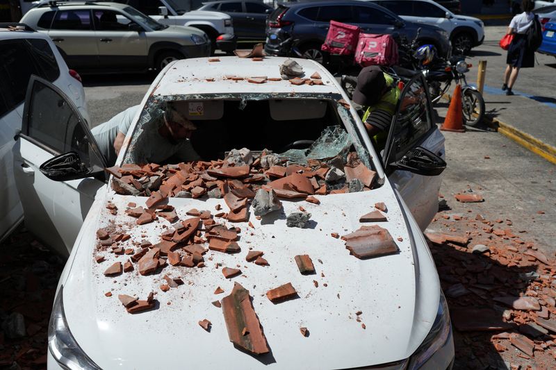 A car damaged by falling debris after an earthquake struck near the southern coast of Panama, in Panama City, Friday. The magnitude 7.7 quake damaged homes, cut power, halted flights and sent residents into the streets.