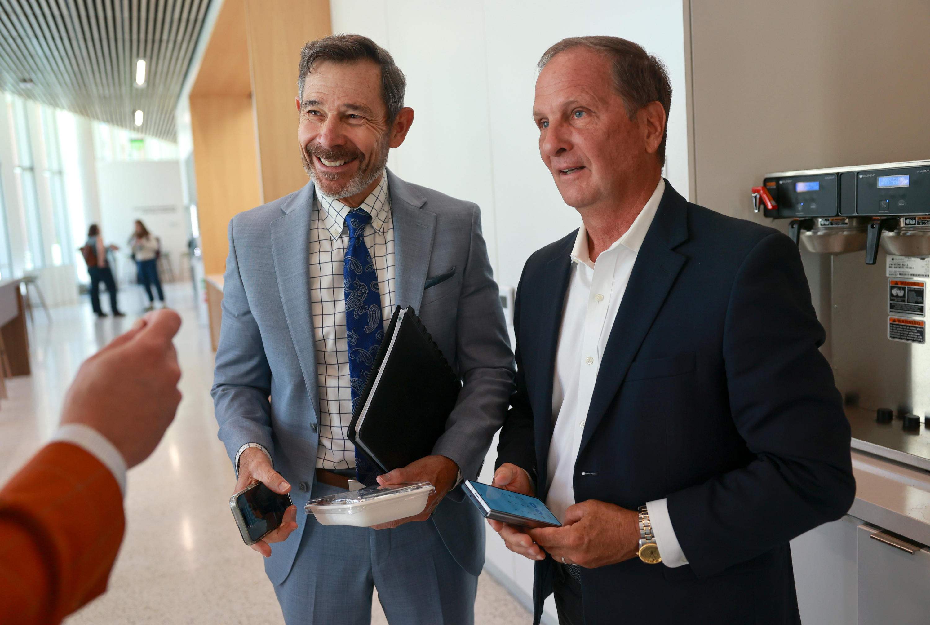 Sen. John Curtis, R-Utah, and former Rep. Chris Stewart, R-Utah, talk at the University of Utah’s Eccles School of Medicine building in Salt Lake City on Friday.