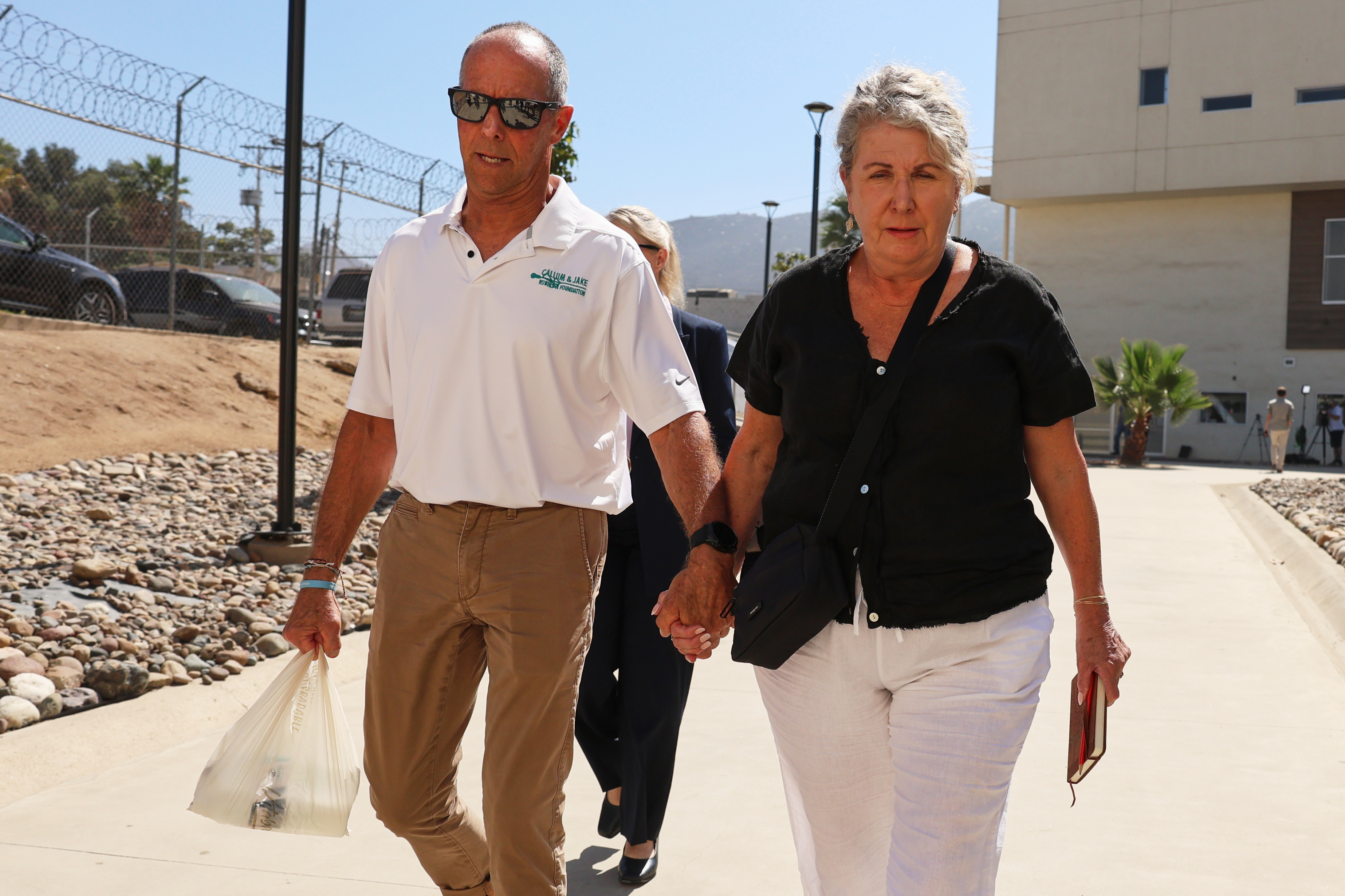 Debra and Martin Robinson, the parents of Australian brothers Callum and Jake Robinson, arrive to court for the trial of the men accused of murdering them, in Ensenada, Mexico, Thursday, Oct. 8, 2026. 
