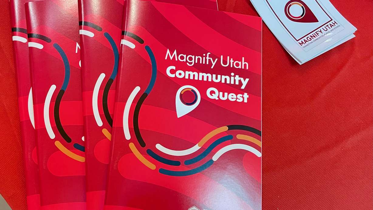 A new initiative, Community Quest, aims to encourage exploration of the state's varied cultures and communities. Red Community Quest booklets are pictured Thursday in South Salt Lake.