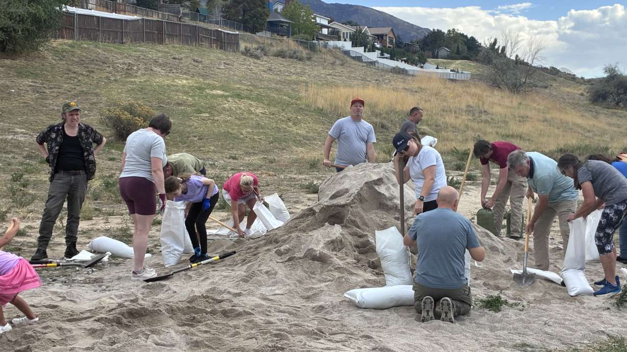 Sandy residents prepare sandbags before strong rain and winds come into Utah, Friday. With remnants of Hurricane Rachel expected to bring rain to Utah, residents are taking precautions against potential flooding.