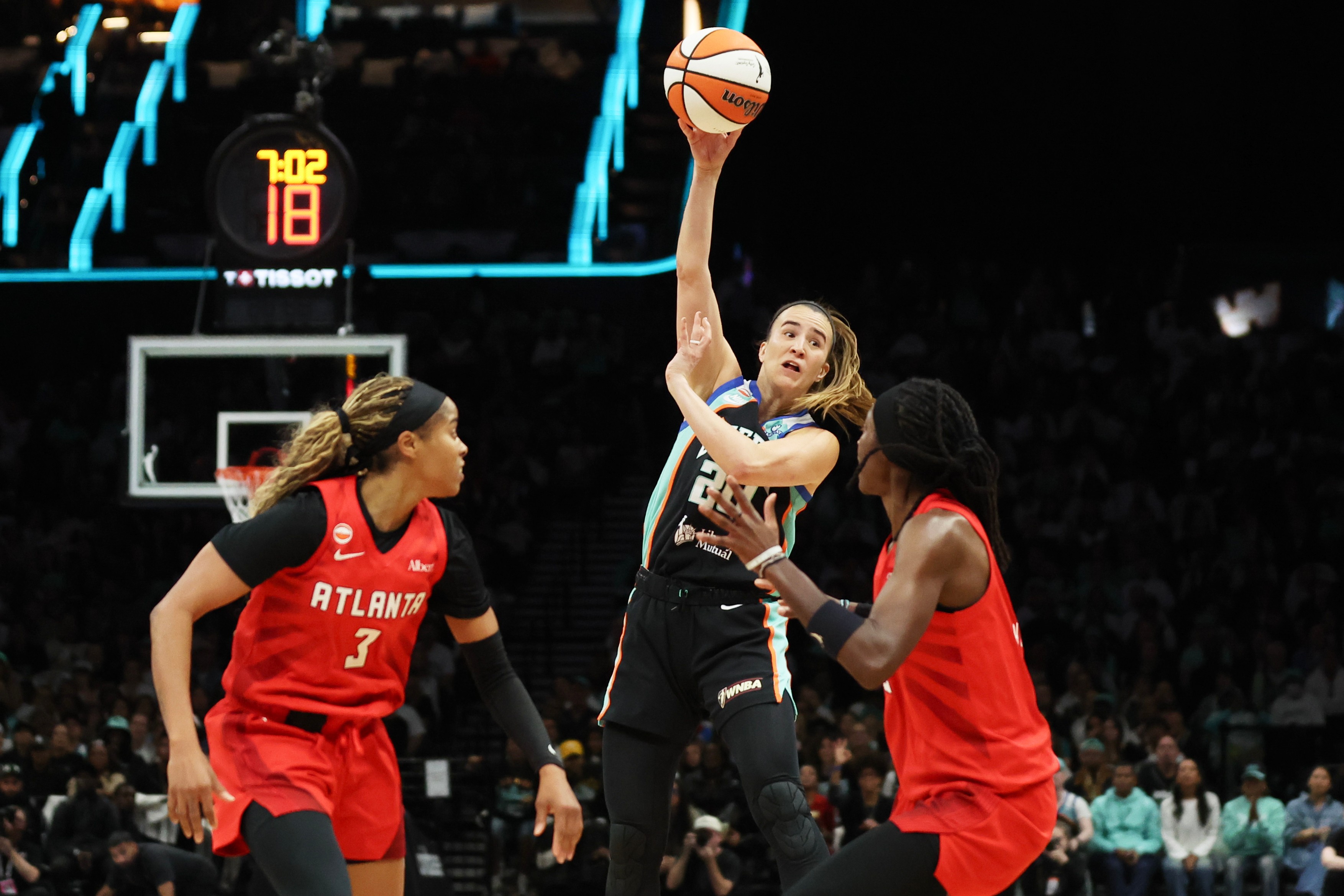 New York Liberty guard Sabrina Ionescu, center, passes the ball against Atlanta Dream guards Jordin Canada (3) and Rhyne Howard, right, during the first half of Game 3 of the WNBA basketball semifinals, Friday, Oct. 9, 2026, in New York. 