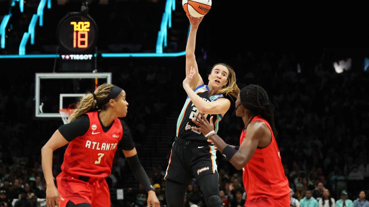 New York Liberty guard Sabrina Ionescu, center, passes the ball against Atlanta Dream guards Jordin Canada (3) and Rhyne Howard, right, during the first half of Game 3 of the WNBA basketball semifinals, Friday, Oct. 9, 2026, in New York.