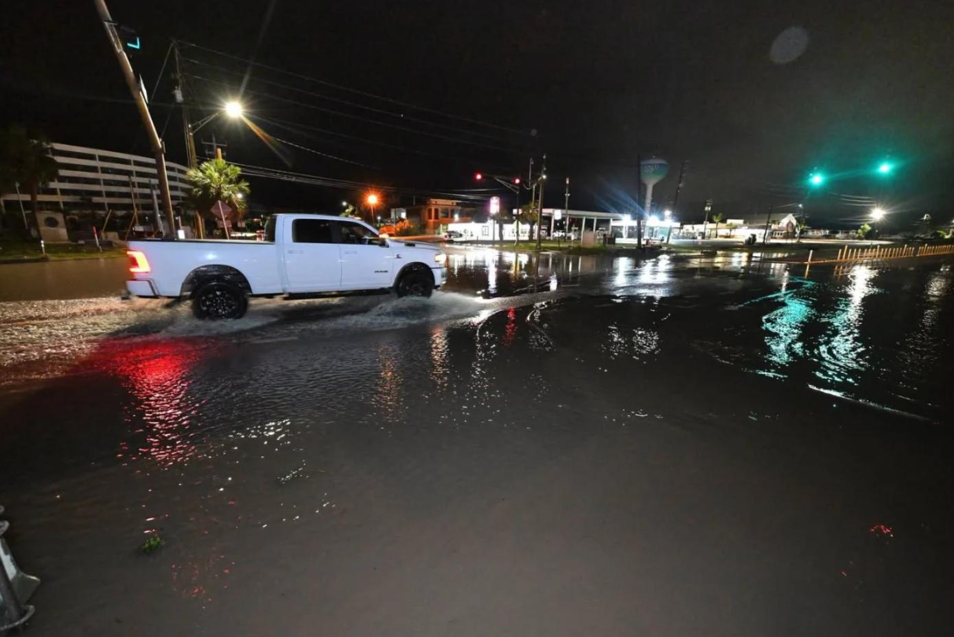 A motorist drives along a flooded road in Okaloosa County, Florida.