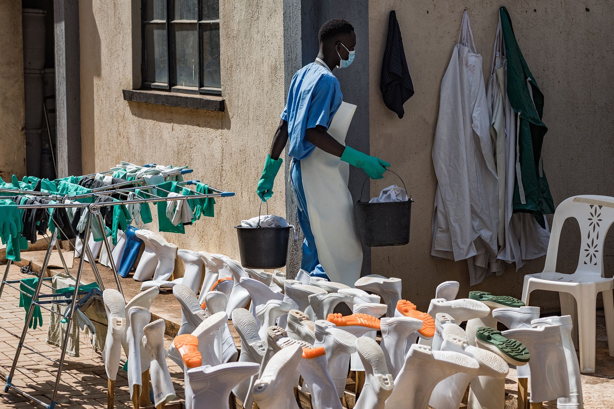 A health worker cleans PPE at the Mulago National Referral Hospital isolation unit in Kampala, Uganda, on July 8.