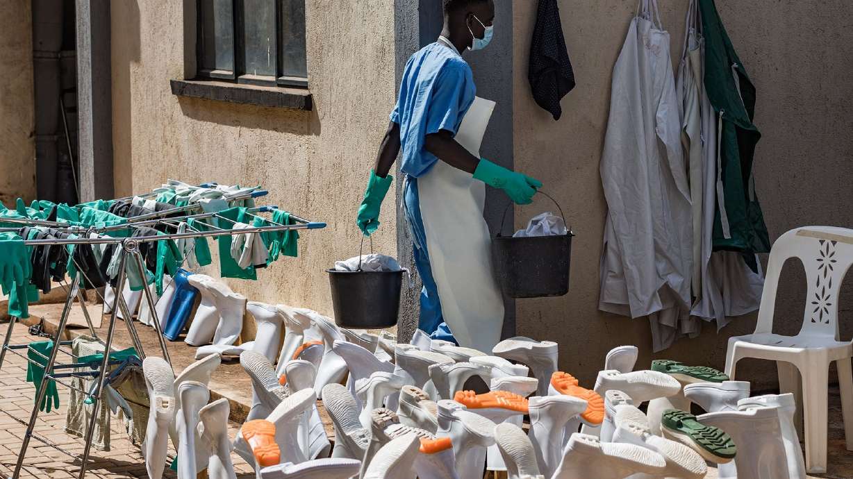 A health worker cleans PPE at the Mulago National Referral Hospital isolation unit in Kampala, Uganda, on July 8.