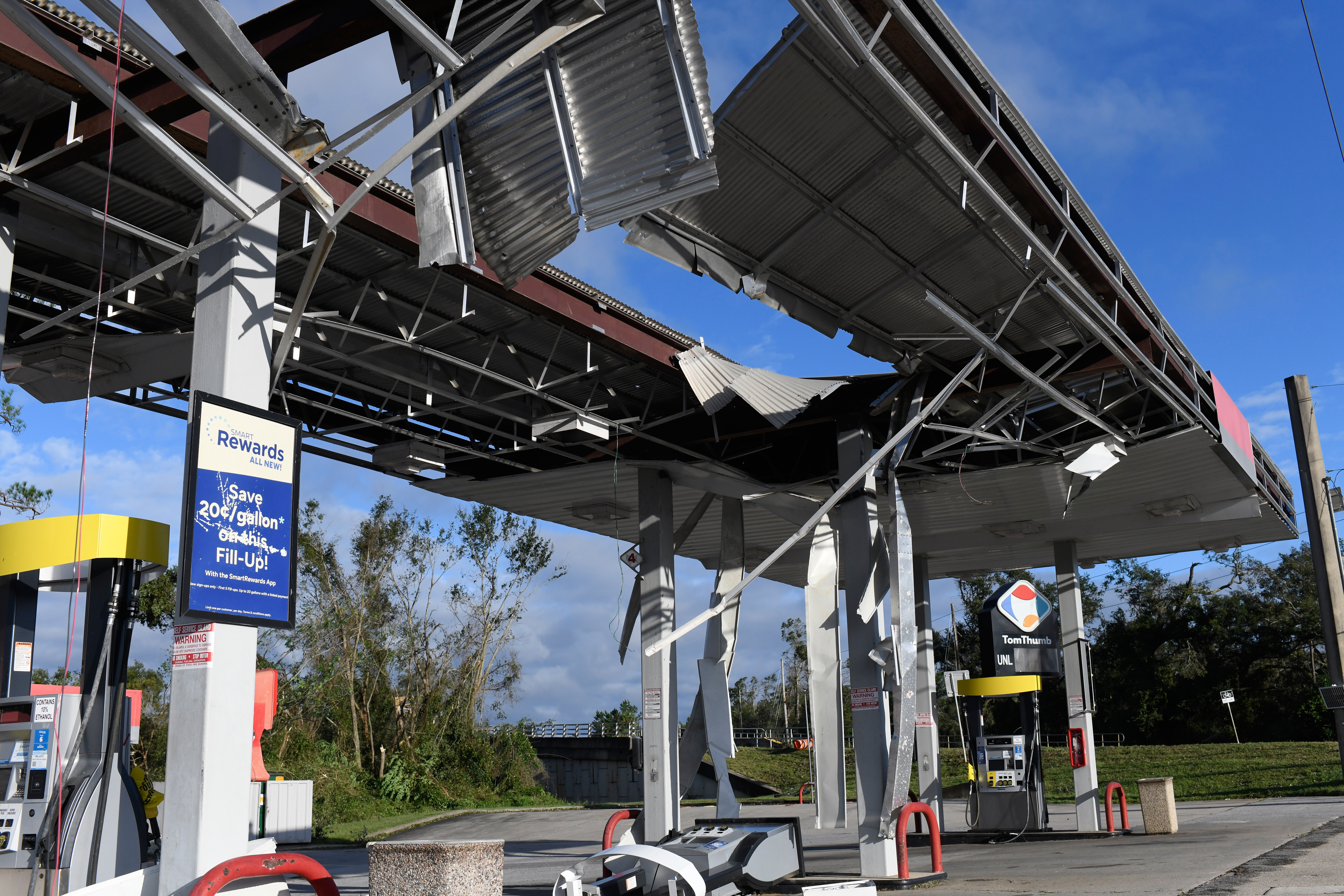 A gas station is damaged by the effects of Hurricane Isaias on Saturday, in East Milton, Fla. The storm has been responsible for four deaths.