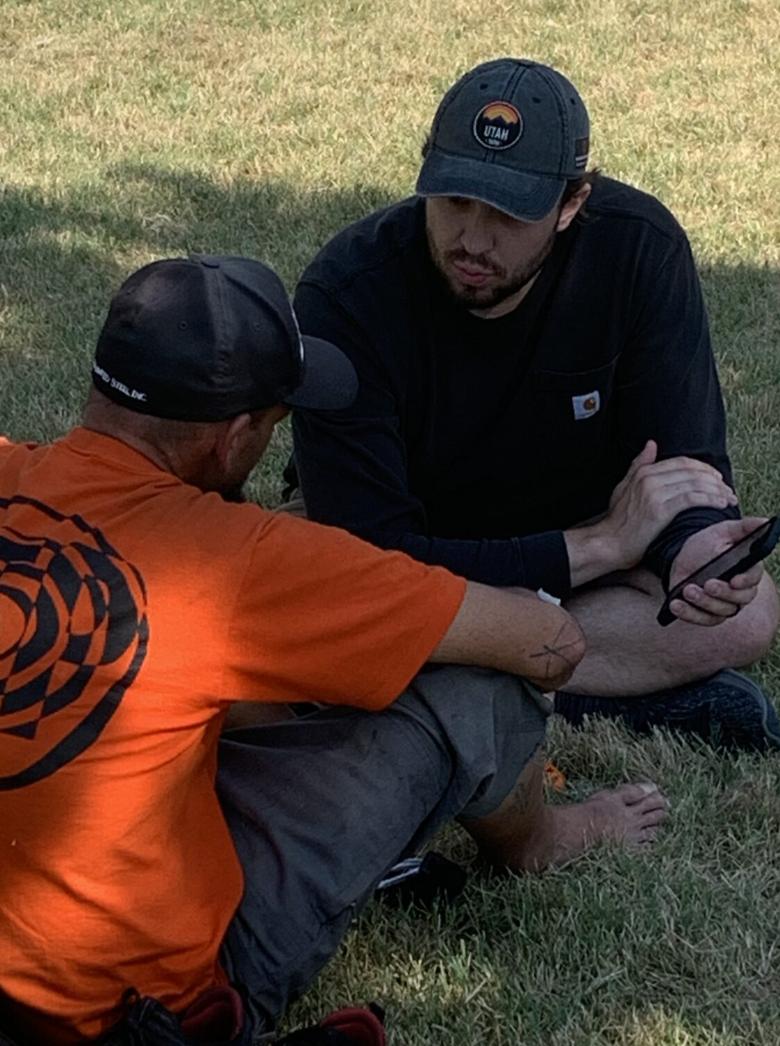 A research assistant in the Department of Parks, Recreation, and Tourism at the University of Utah hands out temperature monitors at Liberty Park in Salt Lake City to understand the impact of extreme temperatures on unsheltered populations.