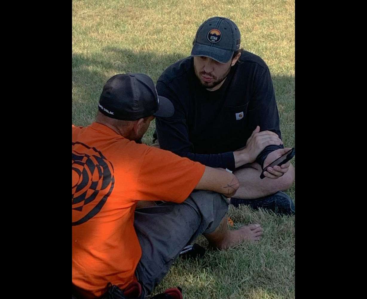 A research assistant in the Department of Parks, Recreation, and Tourism at the University of Utah hands out temperature monitors at Liberty Park in Salt Lake City to understand the impact of extreme temperatures on unsheltered populations.