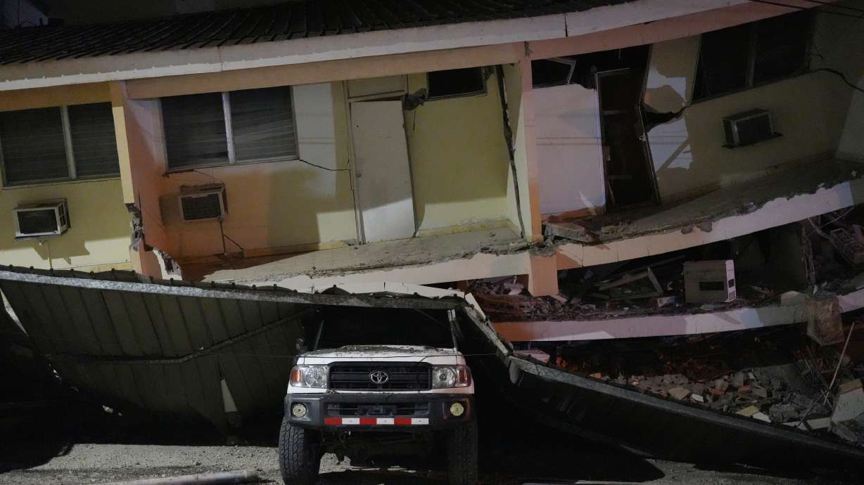 A vehicle lies crushed beneath a collapsed building after an earthquake struck Penonome, Panama, Friday. The country declared a state of emergency on Saturday following two quakes that shook the nation.