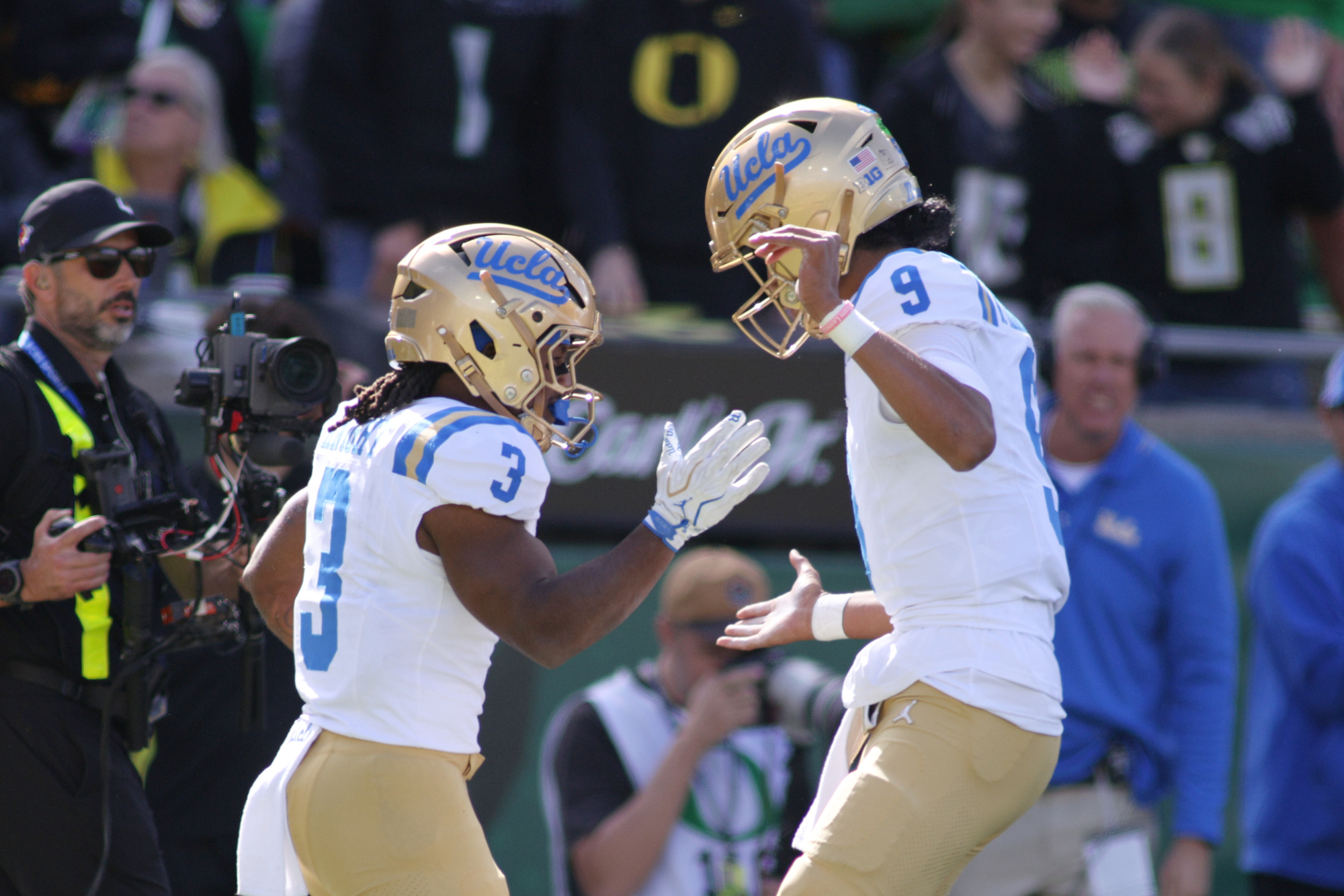 UCLA quarterback Nico Iamaleava (9) congratulates running back Wayne Knight (3) on a touchdown during the first half of an NCAA college football game against Oregon, Saturday, Oct. 10, 2026, in Eugene, Ore. 