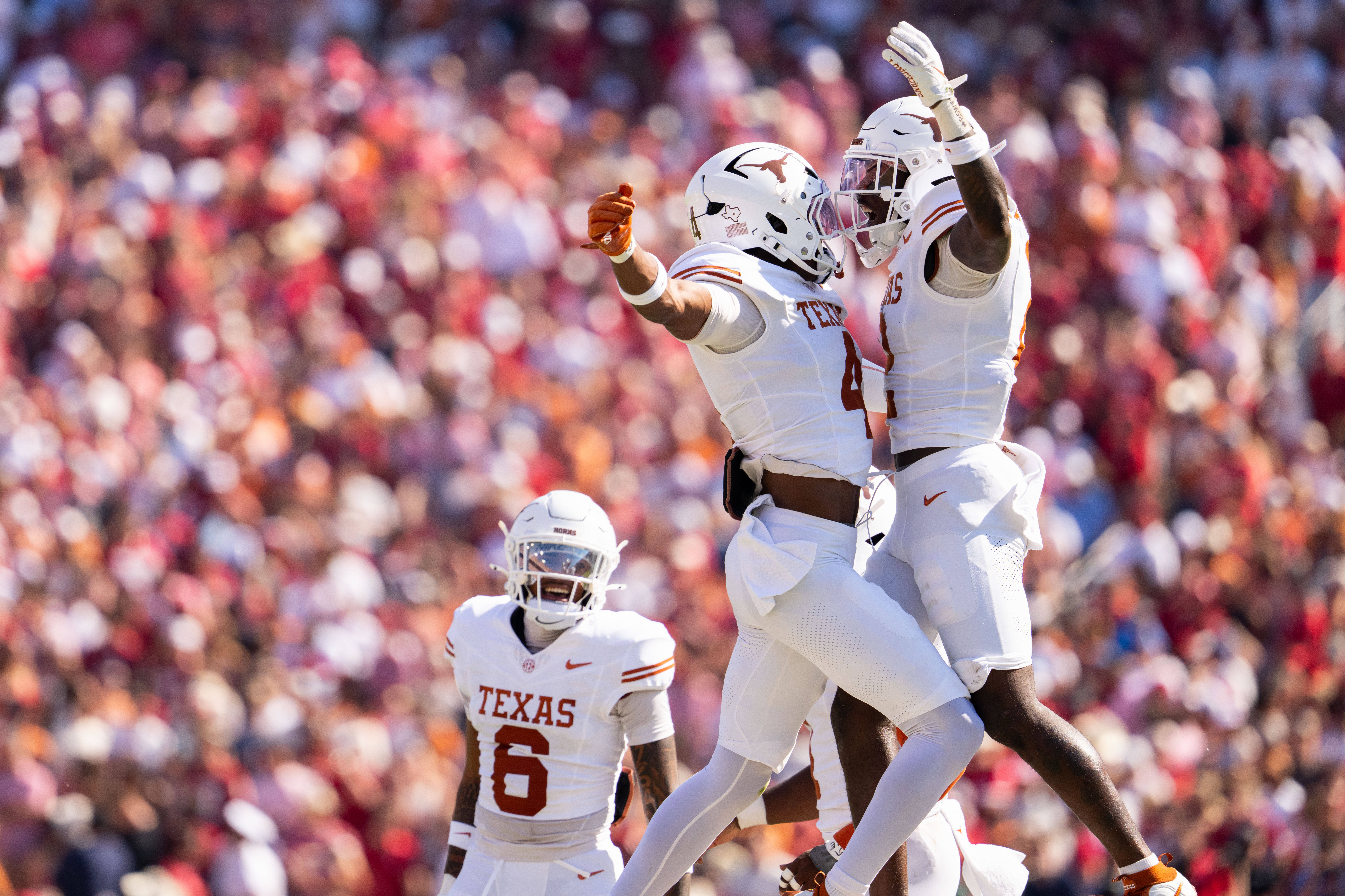 Texas Longhorns defensive backs Jelani McDonald, left, and Derek Williams Jr. celebrate a defensive stop as defensive back Kobe Black (6) looks on during the first half of an NCAA college football game against Oklahoma, Saturday, Oct. 10, 2026, in Dallas. 