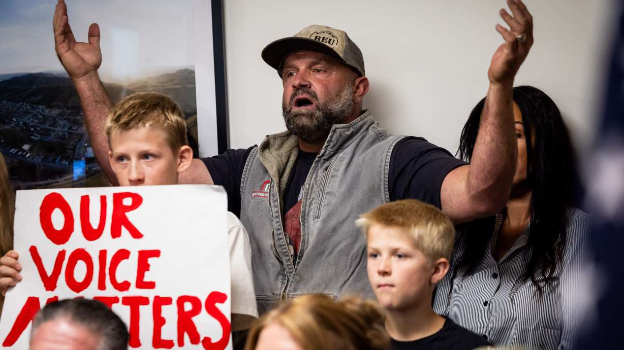 Mark Martineau, center, who has a farm in Mona, and others protest the proposed data center just outside of Mona during the public comment portion of the Juab County Commission meeting at Rocky Ridge Town Hall in Rocky Ridge on Sept. 8.