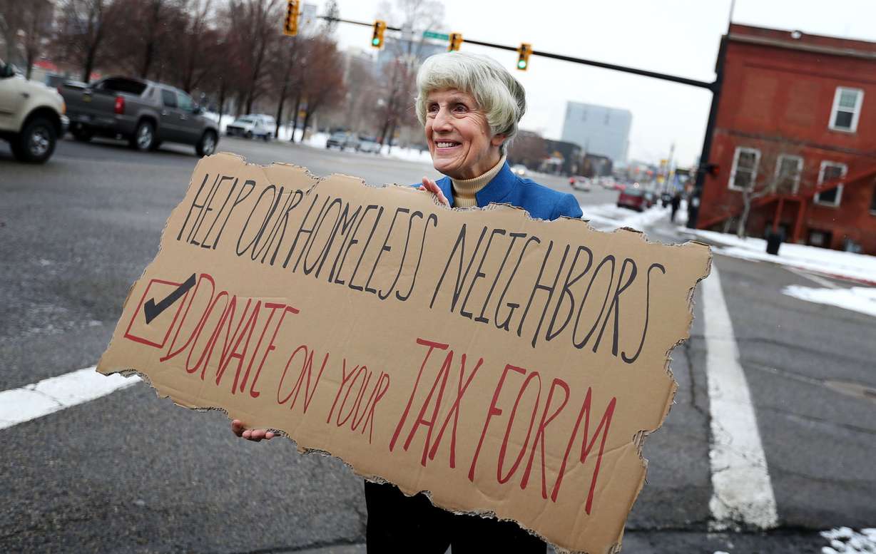 Homeless advocate Pamela Atkinson encourages passersby to support the Pamela Atkinson Homeless Trust Fund through donations on their tax forms while standing outside the Fourth Street Clinic in Salt Lake City on Feb. 4, 2016. Atkinson died on Saturday at the age of 93.