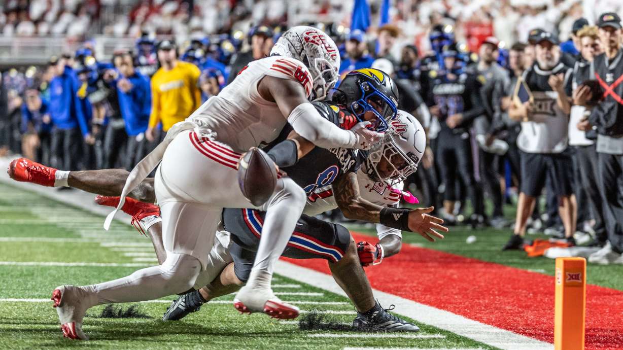 Kansas Jayhawks quarterback Isaiah Marshall (8) is wrapped up at the goal line by Utah Utes safety Rabbit Evans (1) and linebacker Johnathan Hall (7) to prevent a fourth down touchdown during a game at Rice-Eccles Stadium in Salt Lake City on Saturday, Oct. 10, 2026.