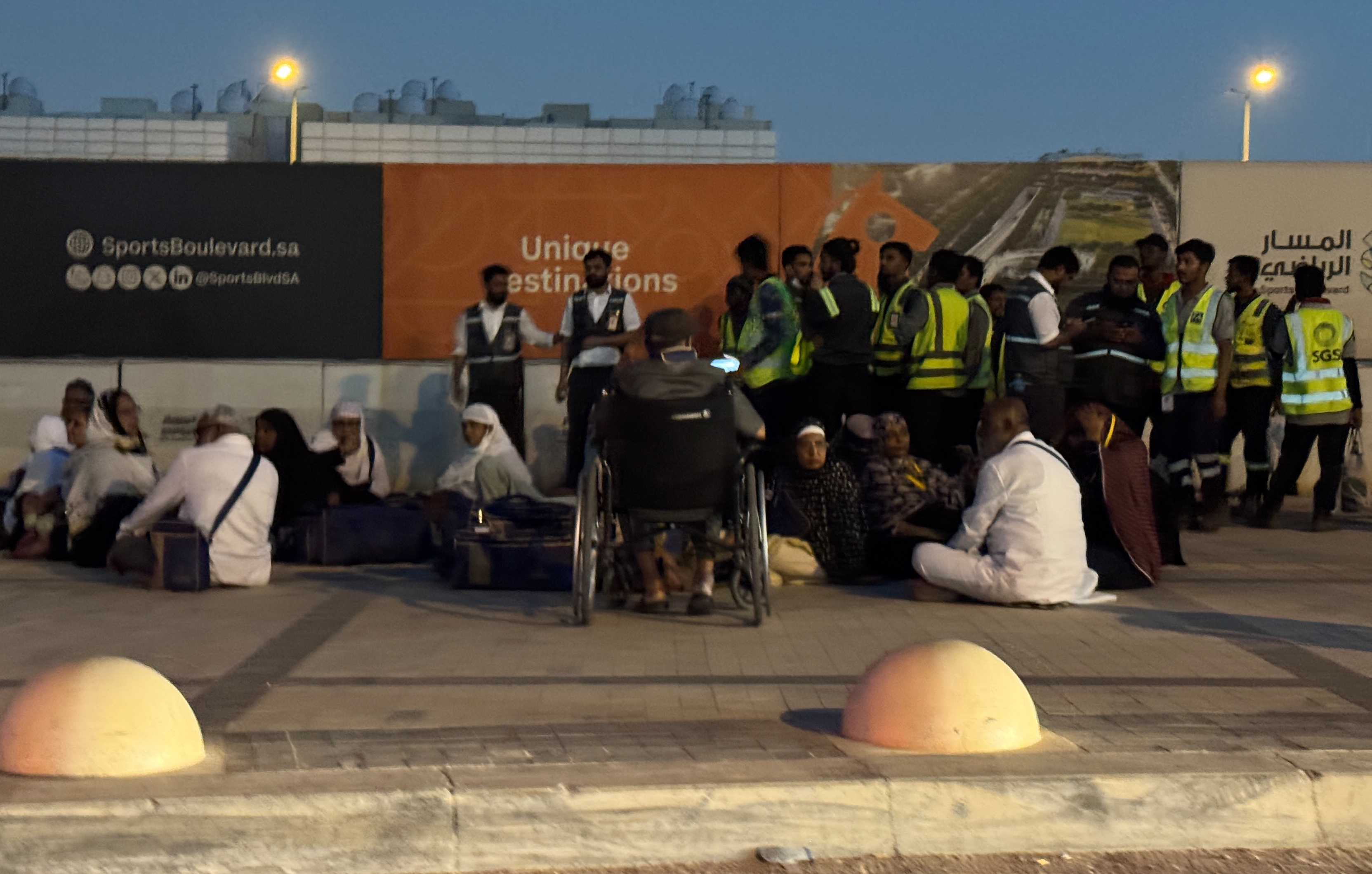 People gather outside a metro station on the road to King Khalid International Airport in Riyadh, Saudi Arabia, Saturday. Houthi rebels claimed Saudi-led strikes on Yemen hit their held areas on Tuesday.