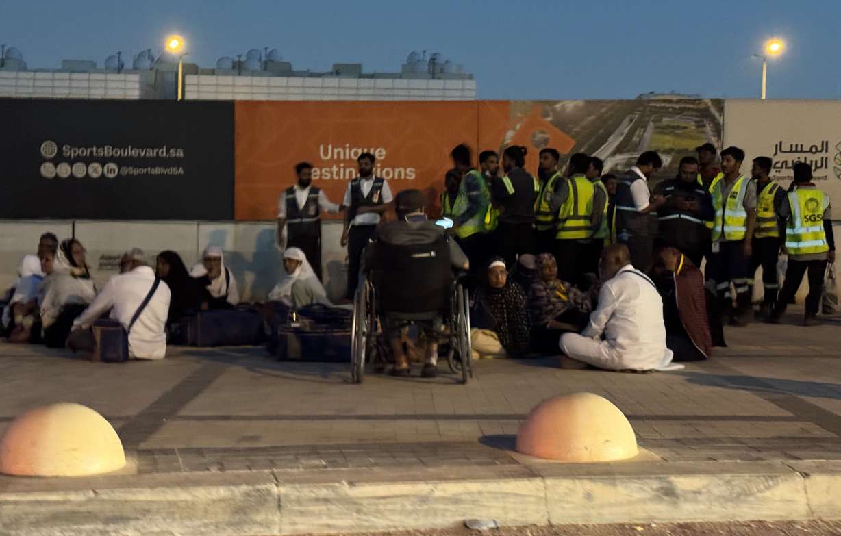 People gather outside a metro station on the road to King Khalid International Airport in Riyadh, Saudi Arabia, Saturday. Houthi rebels claimed Saudi-led strikes on Yemen hit their held areas on Tuesday.
