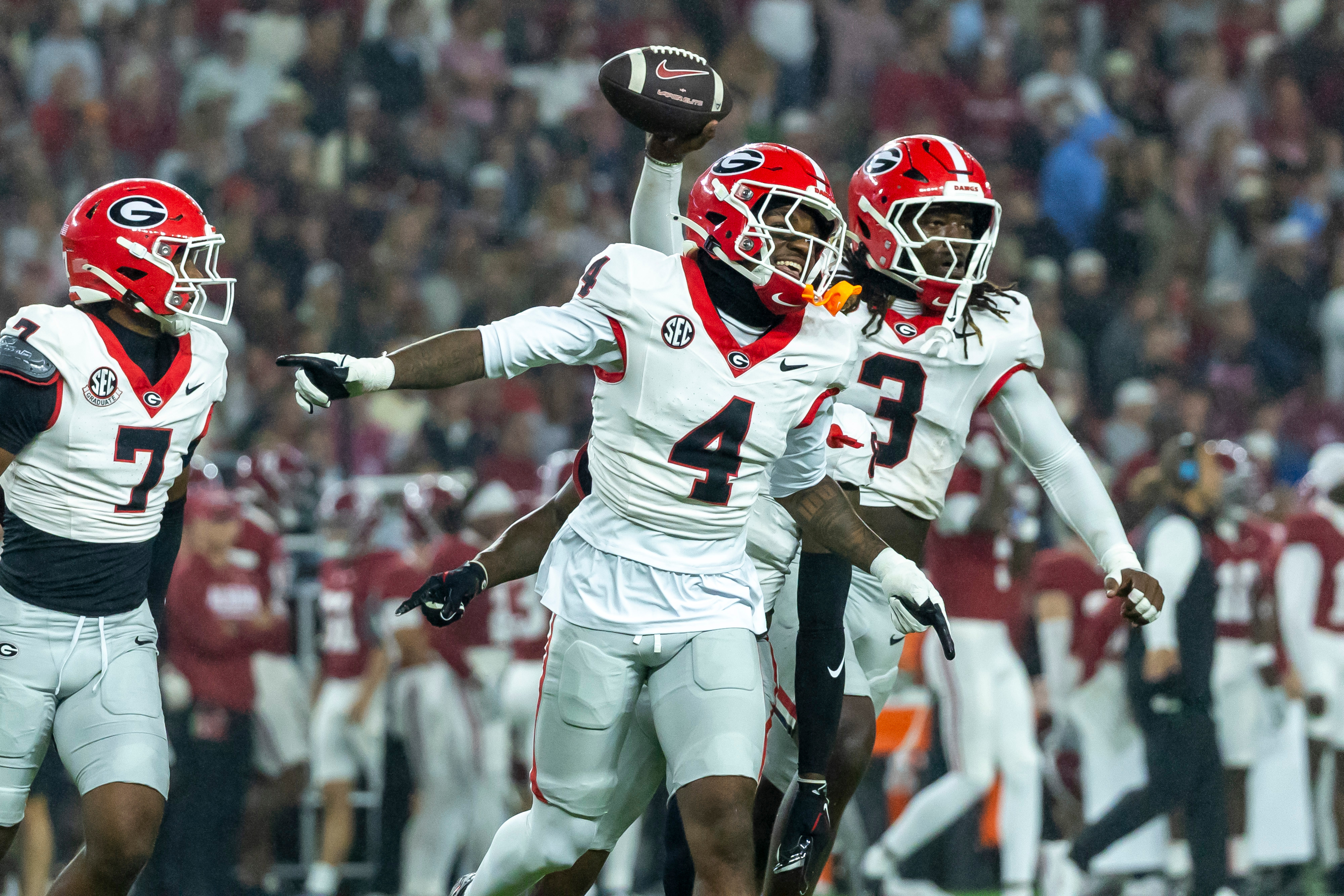 Georgia defensive back KJ Bolden (4) and linebacker Quintavius Johnson (3) celebrate after Johnson's fumble recovery during the first half of an NCAA college football game against Alabama, Saturday, Oct. 10, 2026, in Tuscaloosa, Ala.