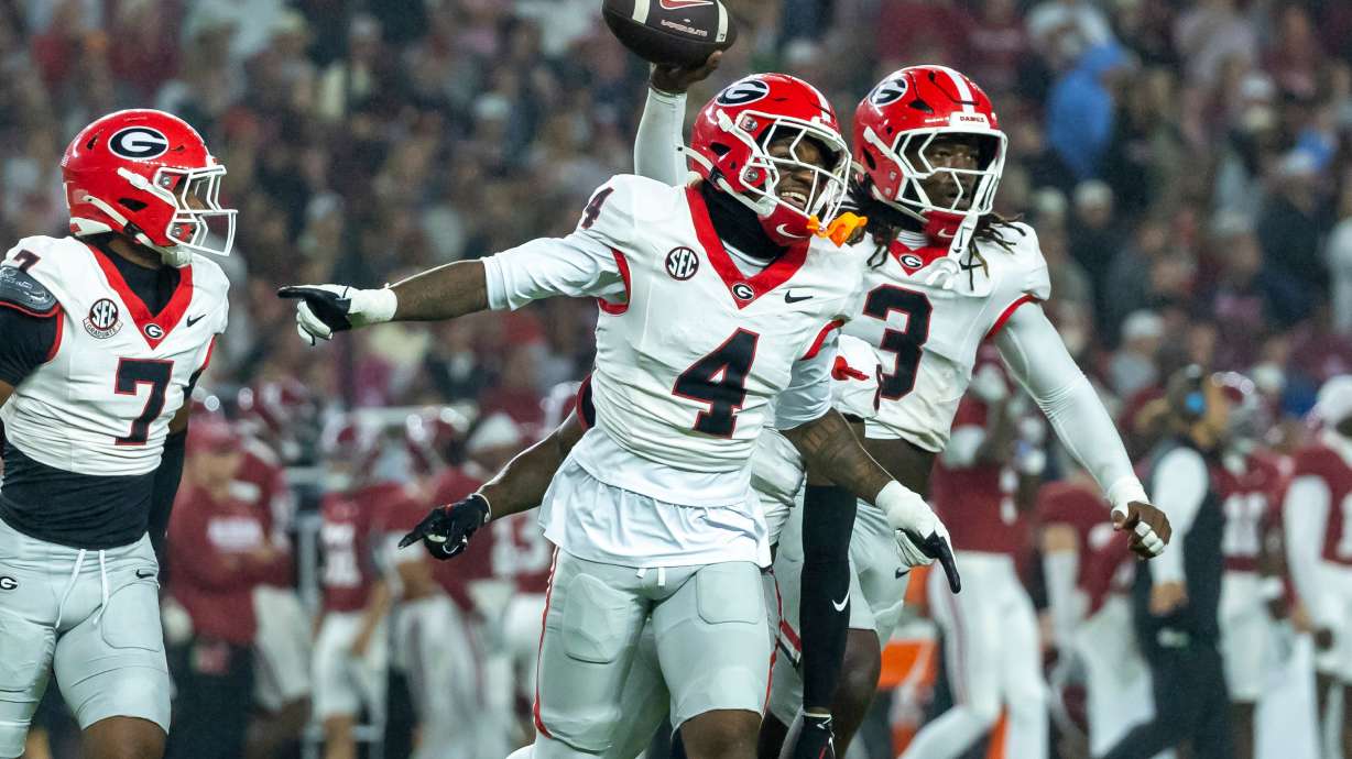 Georgia defensive back KJ Bolden (4) and linebacker Quintavius Johnson (3) celebrate after Johnson's fumble recovery during the first half of an NCAA college football game against Alabama, Saturday, Oct. 10, 2026, in Tuscaloosa, Ala.