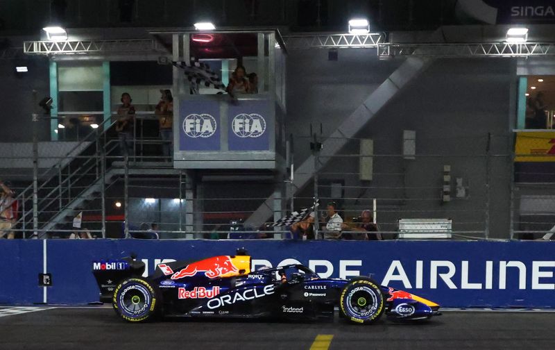 Formula One F1 - Singapore Grand Prix - Marina Bay Street Circuit, Singapore - October 11, 2026 Red Bull's Max Verstappen passes the chequered flag to win the Singapore Grand Prix
