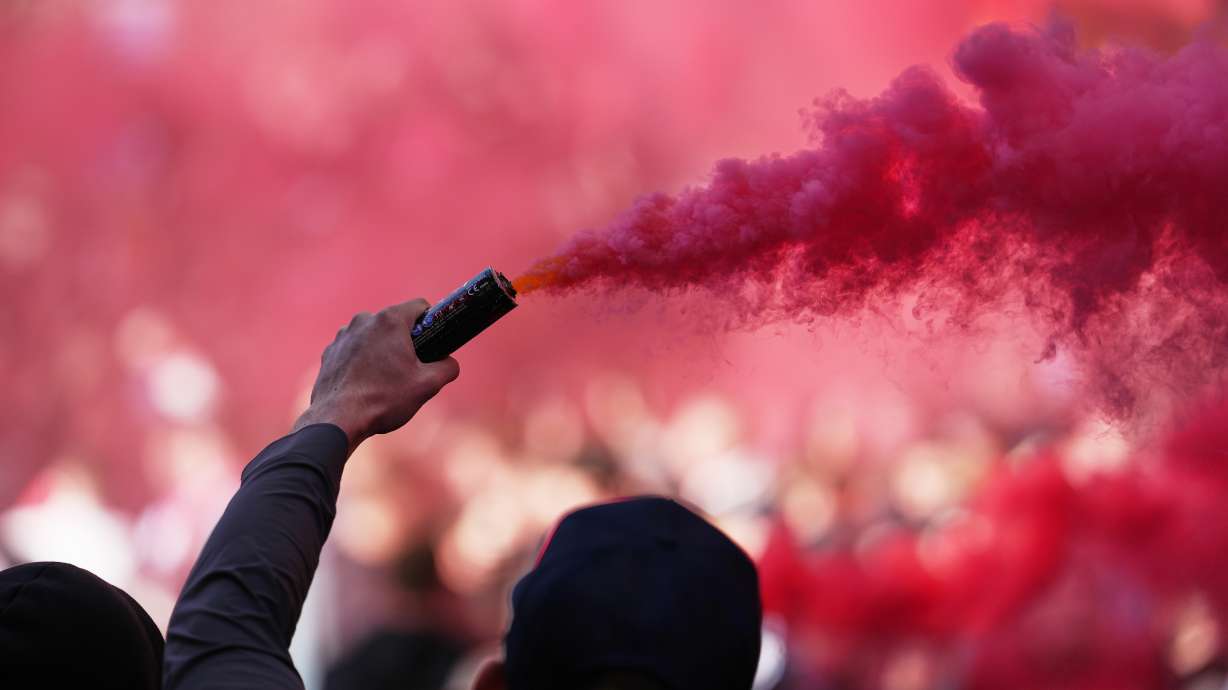 Liverpool fans light flares before the English Premier League soccer match between Liverpool and Manchester City in Liverpool, England, Sunday, Oct. 11, 2026.