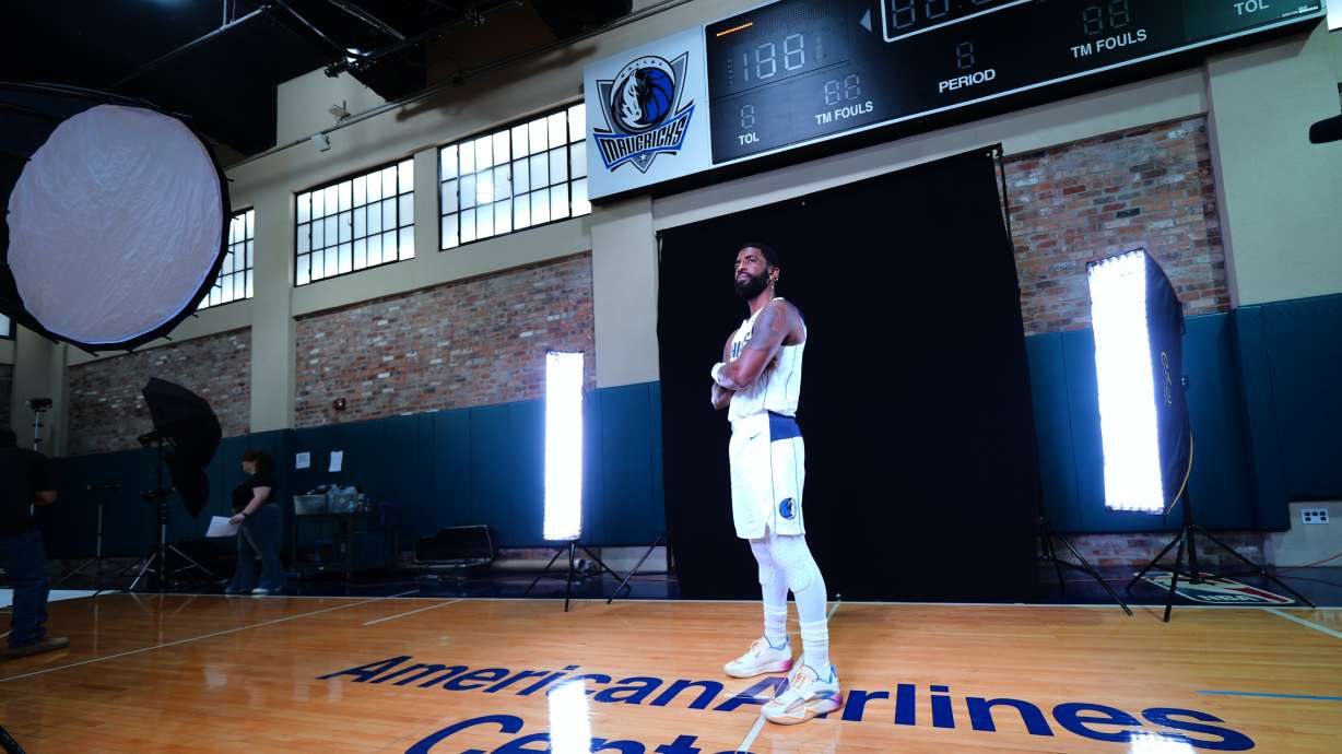 Dallas Mavericks' Kyrie Irving poses for photographs during his team's NBA basketball media day Friday, Sept. 25, 2026, in Dallas.