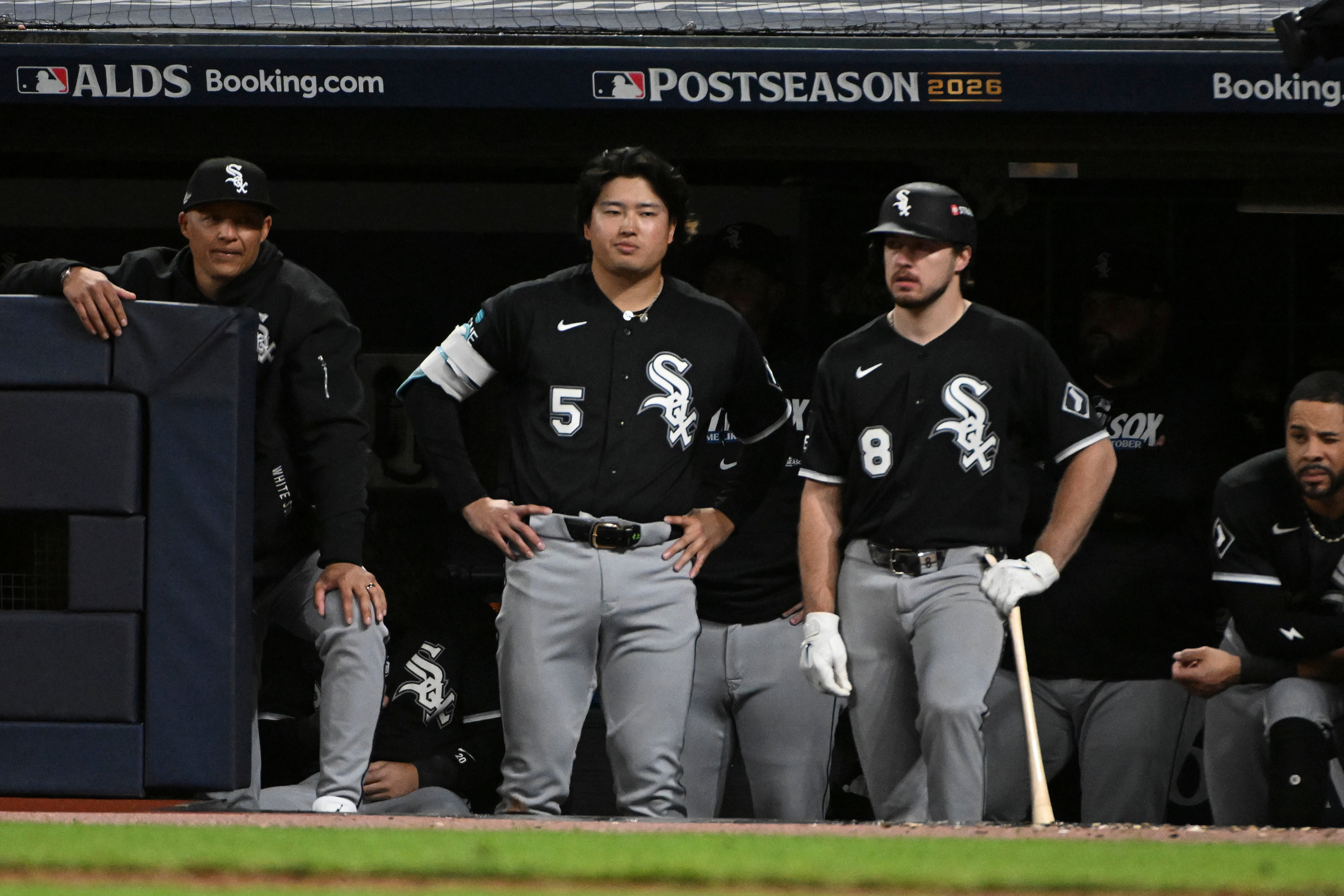 Chicago White Sox first baseman Munetaka Murakami (5) and catcher Kyle Teel (8) watch from the dugout during the eighth inning of Game 5 of baseball's American League Division Series against the Cleveland Guardians, Saturday, Oct. 10, 2026, in Cleveland. 