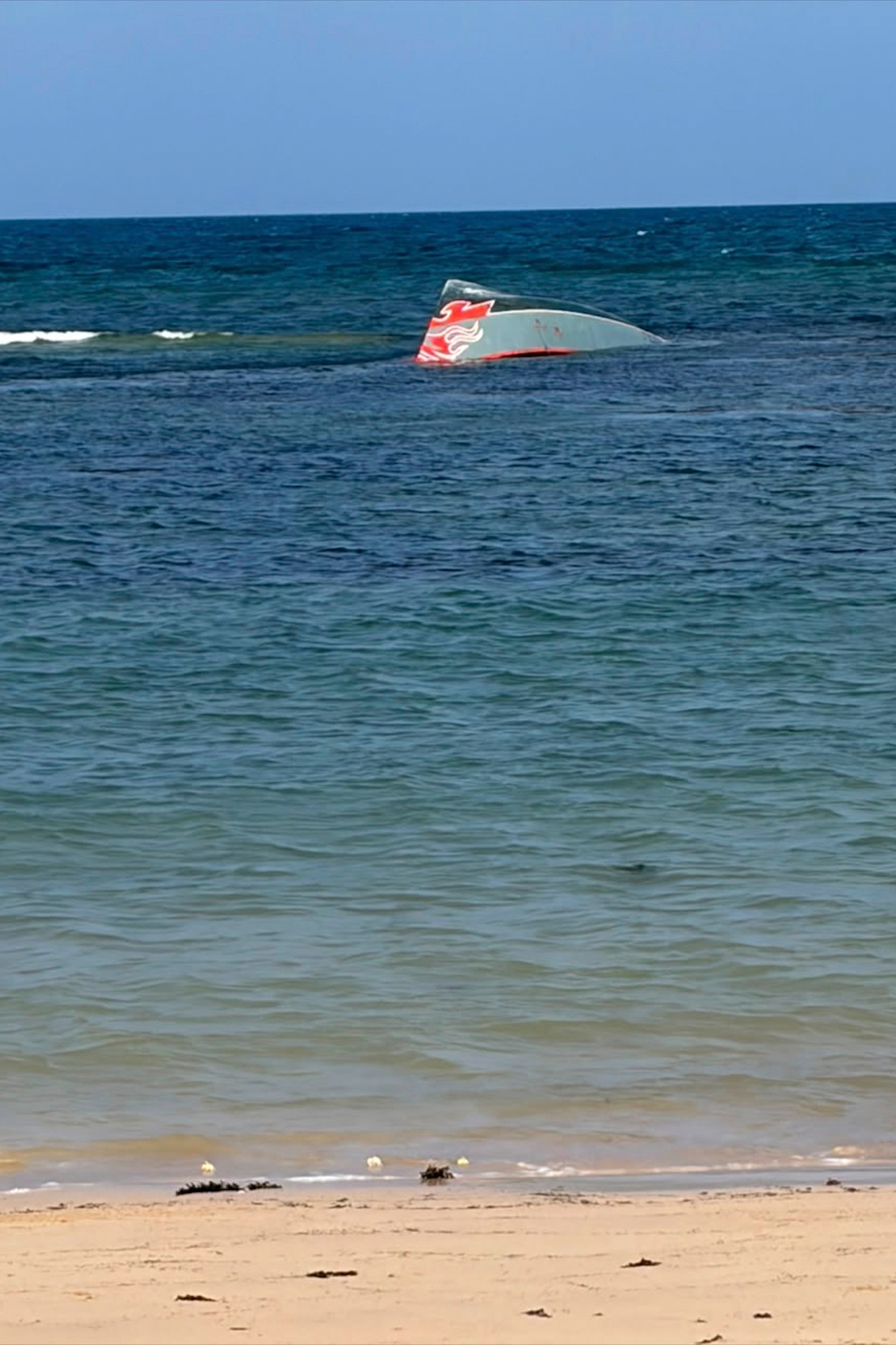 This image provided by the International Organization for Migration shows a boat after it capsized near Guhere, north of Obock, in Djibouti, Saturday.