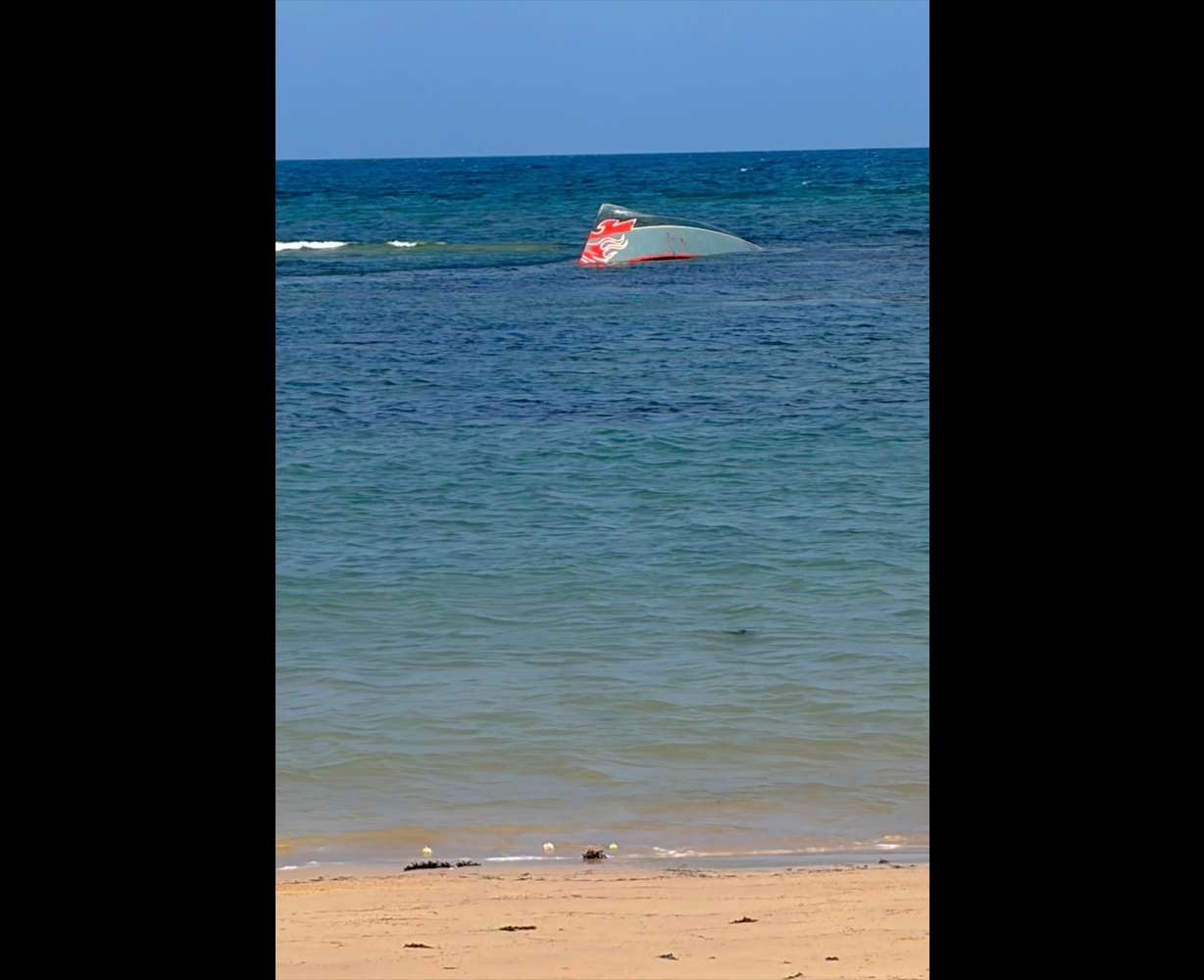 This image provided by the International Organization for Migration shows a boat after it capsized near Guhere, north of Obock, in Djibouti, Saturday.