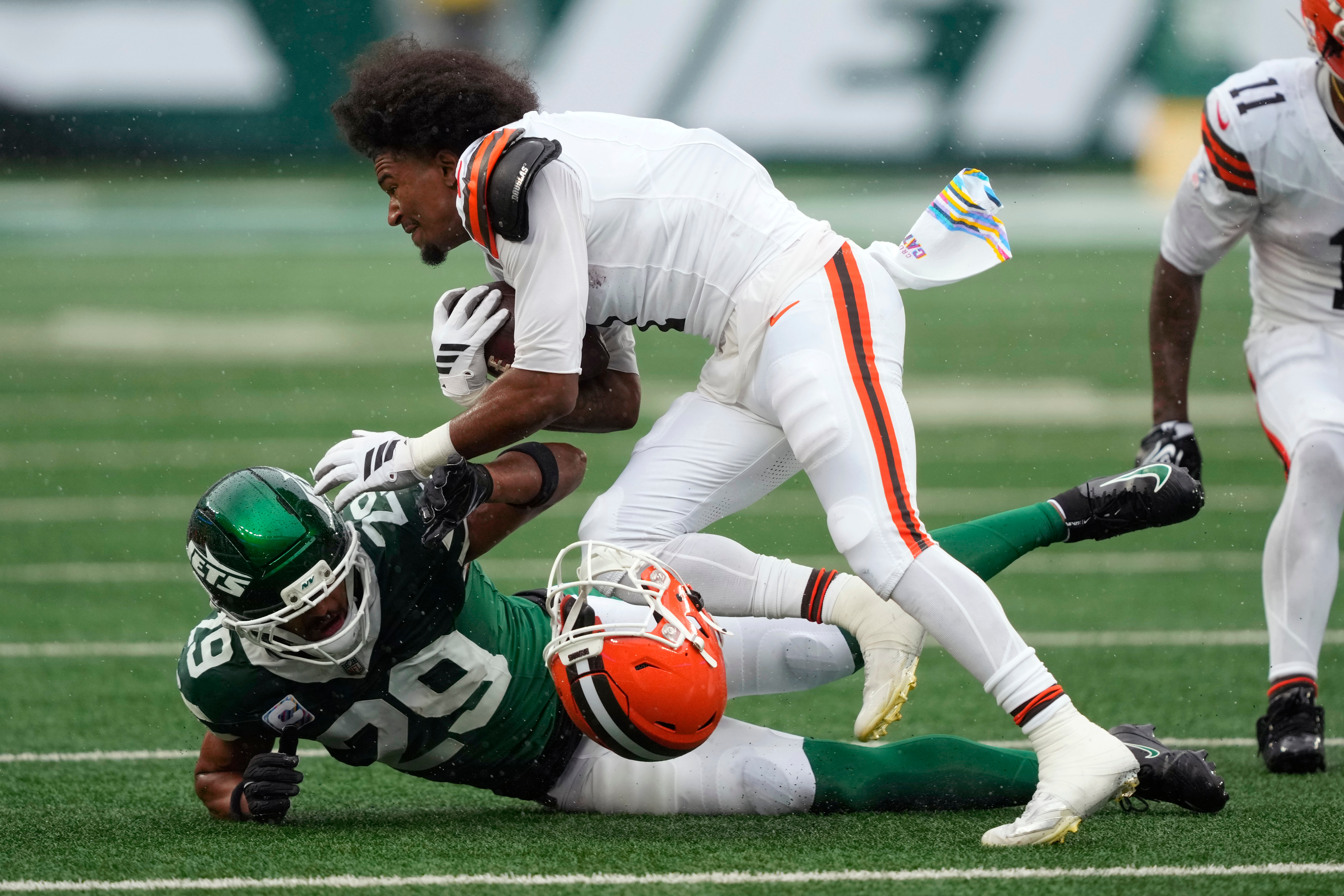Cleveland Browns wide receiver Kc Concepcion loses his helmet as he is tackled by New York Jets safety Minkah Fitzpatrick (29) during the first half of an NFL football game, Sunday, Oct. 11, 2026, in East Rutherford, N.J. 