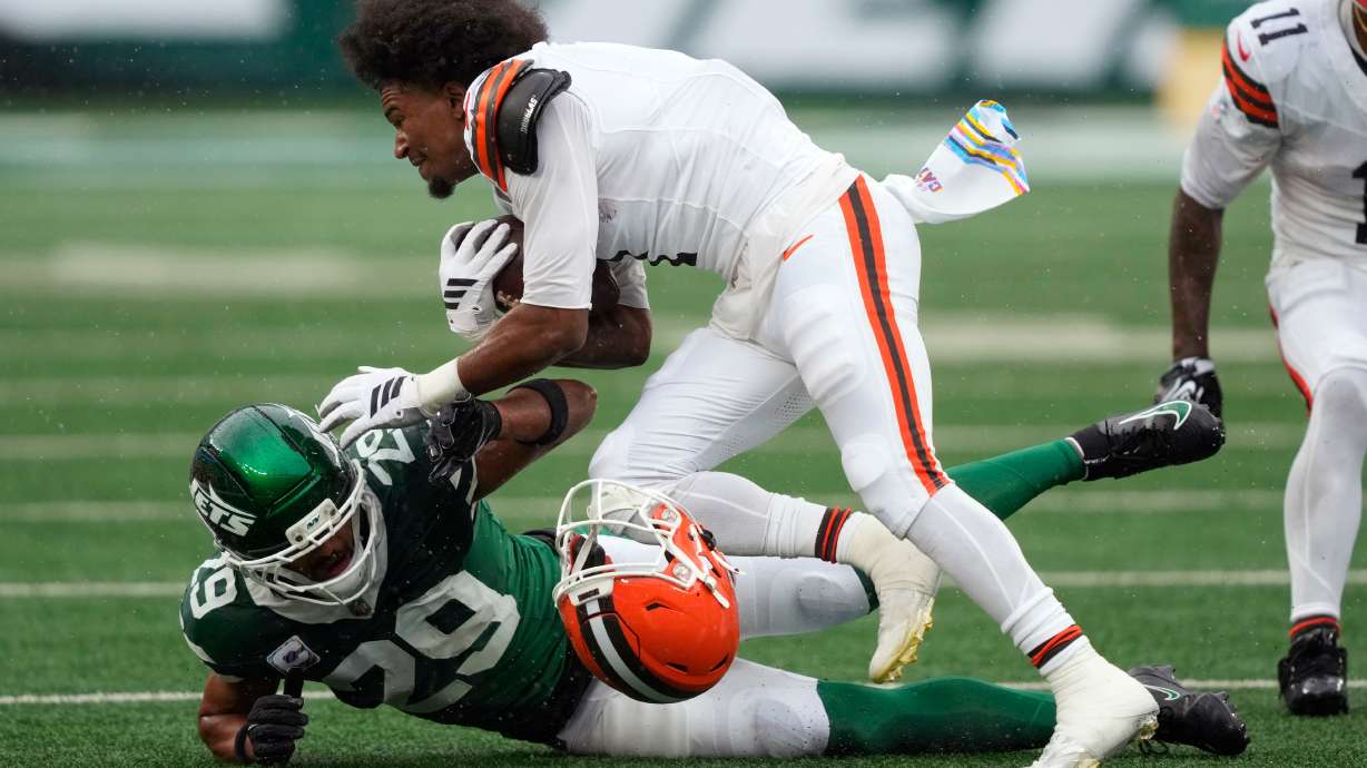 Cleveland Browns wide receiver Kc Concepcion loses his helmet as he is tackled by New York Jets safety Minkah Fitzpatrick (29) during the first half of an NFL football game, Sunday, Oct. 11, 2026, in East Rutherford, N.J.