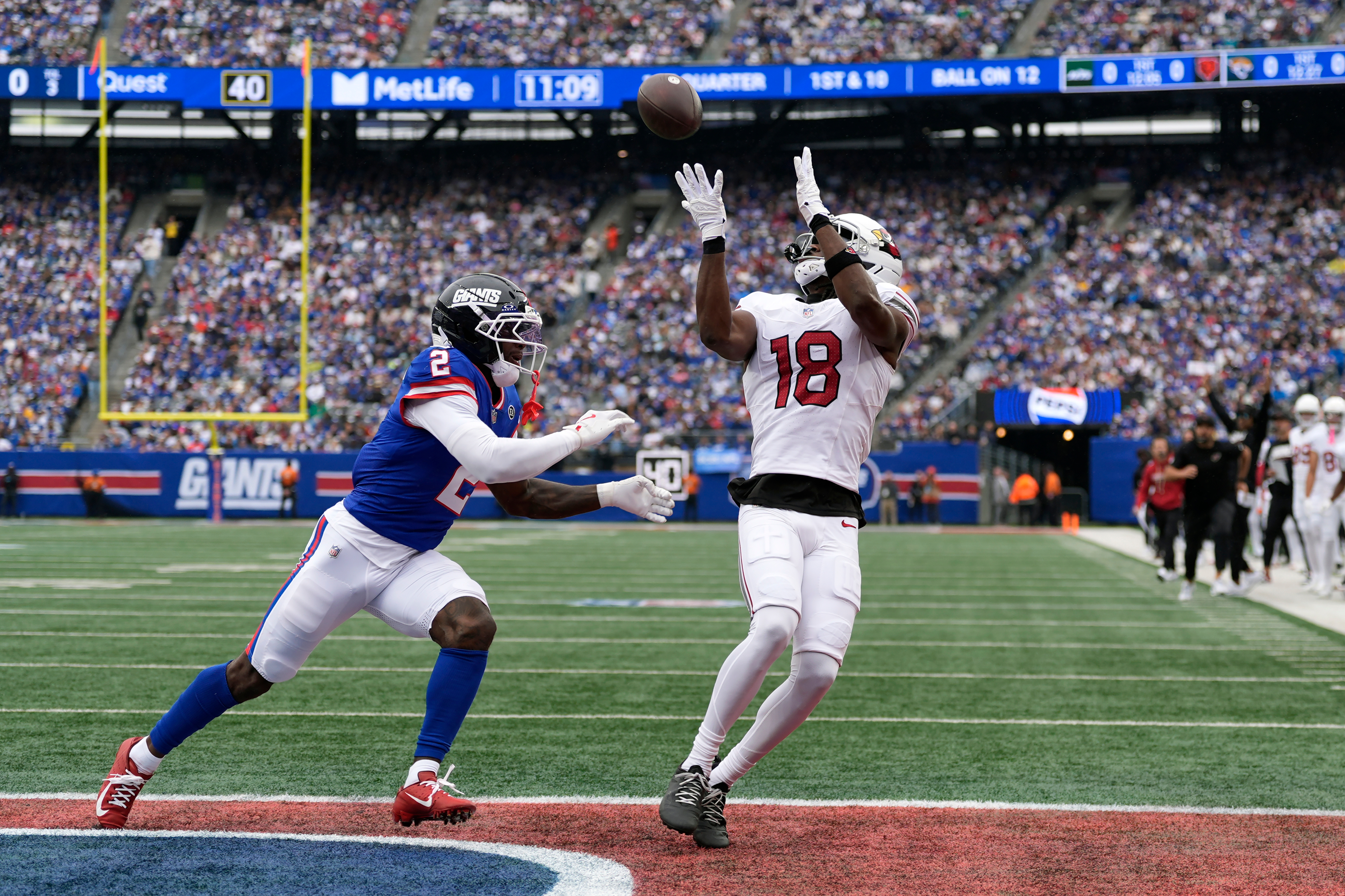 Arizona Cardinals wide receiver Marvin Harrison Jr. (18) makes a touchdown catch against New York Giants cornerback Deonte Banks (2) during an NFL football game, in East Rutherford, N.J., Sunday, Oct. 4, 2026. 