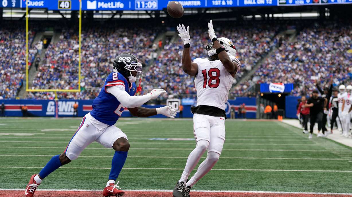 Arizona Cardinals wide receiver Marvin Harrison Jr. (18) makes a touchdown catch against New York Giants cornerback Deonte Banks (2) during an NFL football game, in East Rutherford, N.J., Sunday, Oct. 4, 2026.