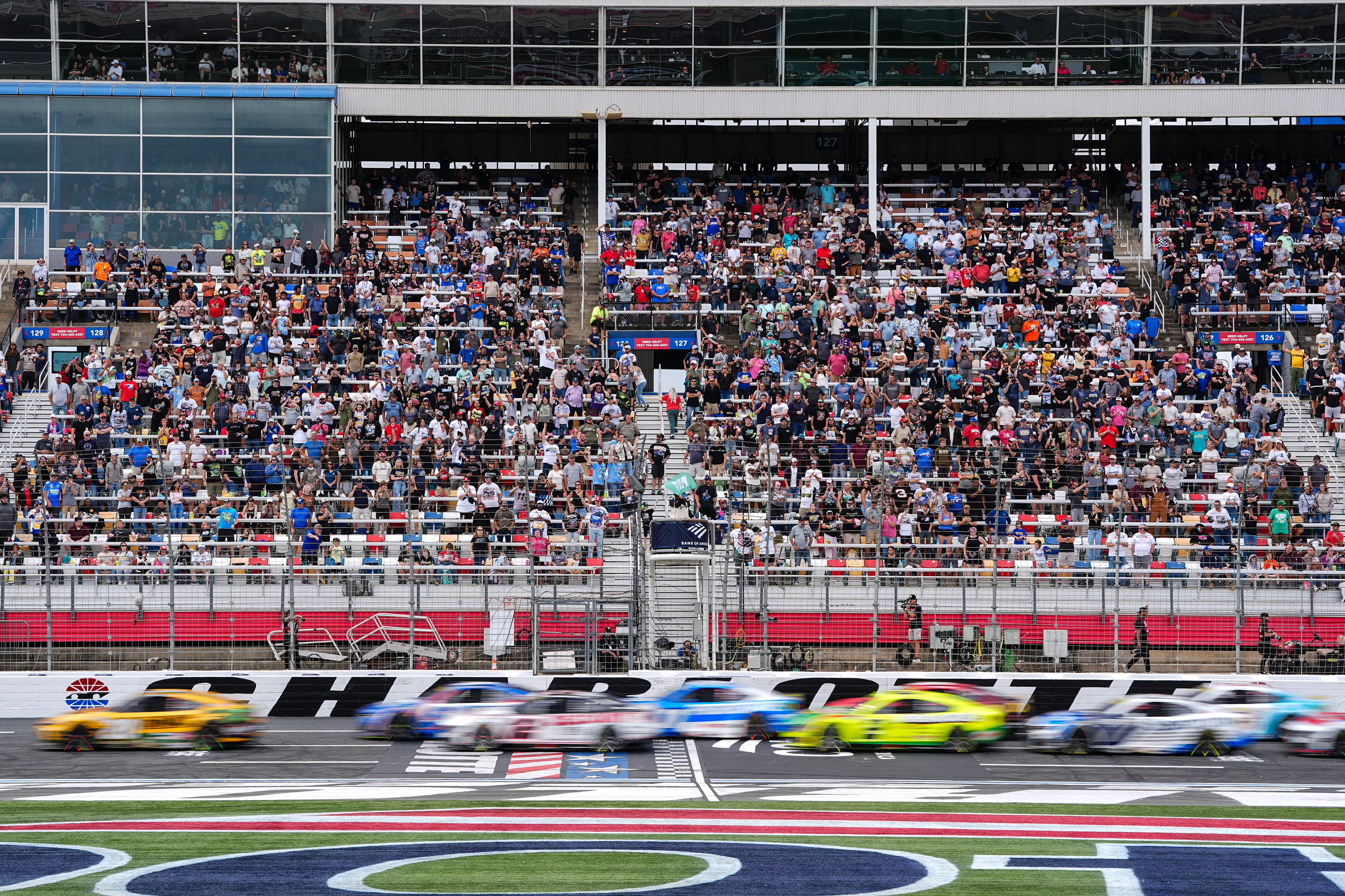 A pack of cars come to a green flag restart during a NASCAR Cup Series auto race, Sunday, Oct. 11, 2026, in Concord, N.C. 