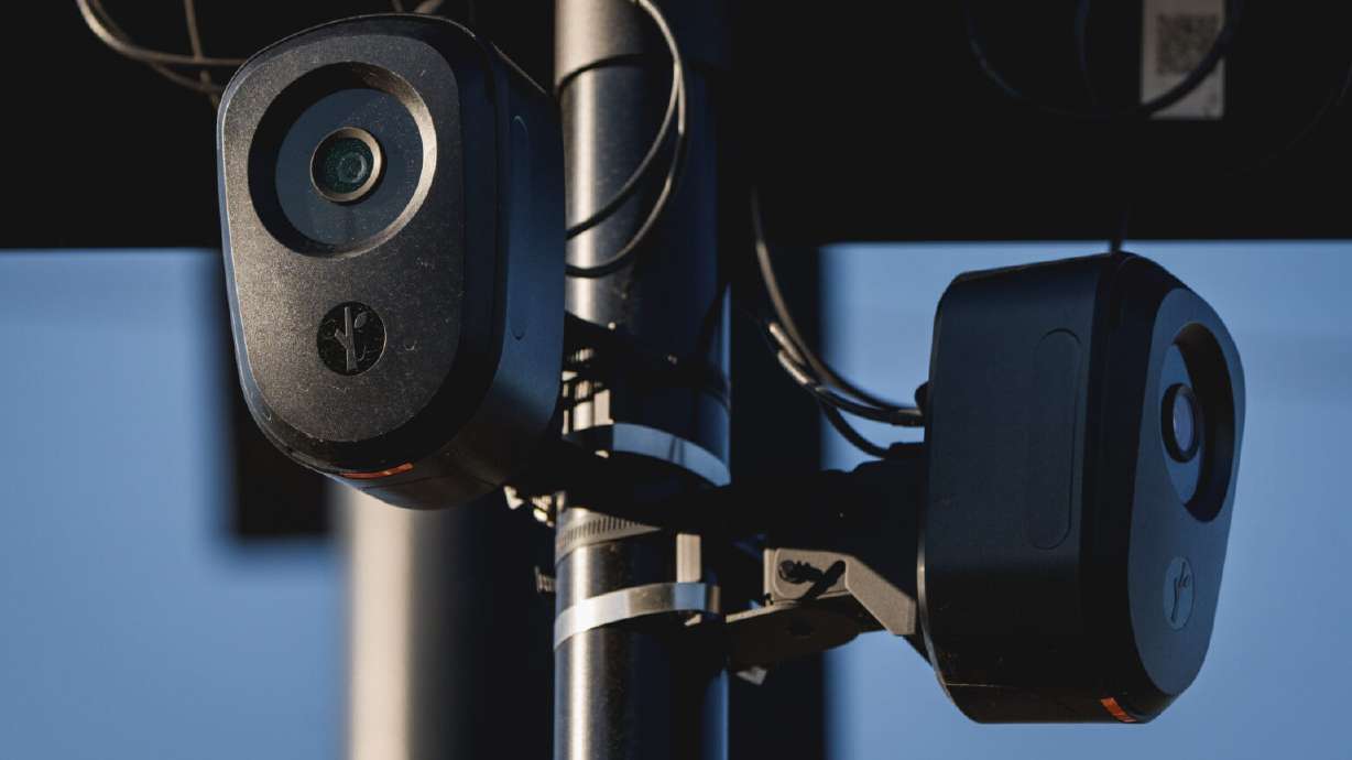 Flock Safety cameras are mounted on a pole in the parking lot of the Home Depot in Salt Lake City on Aug. 25.