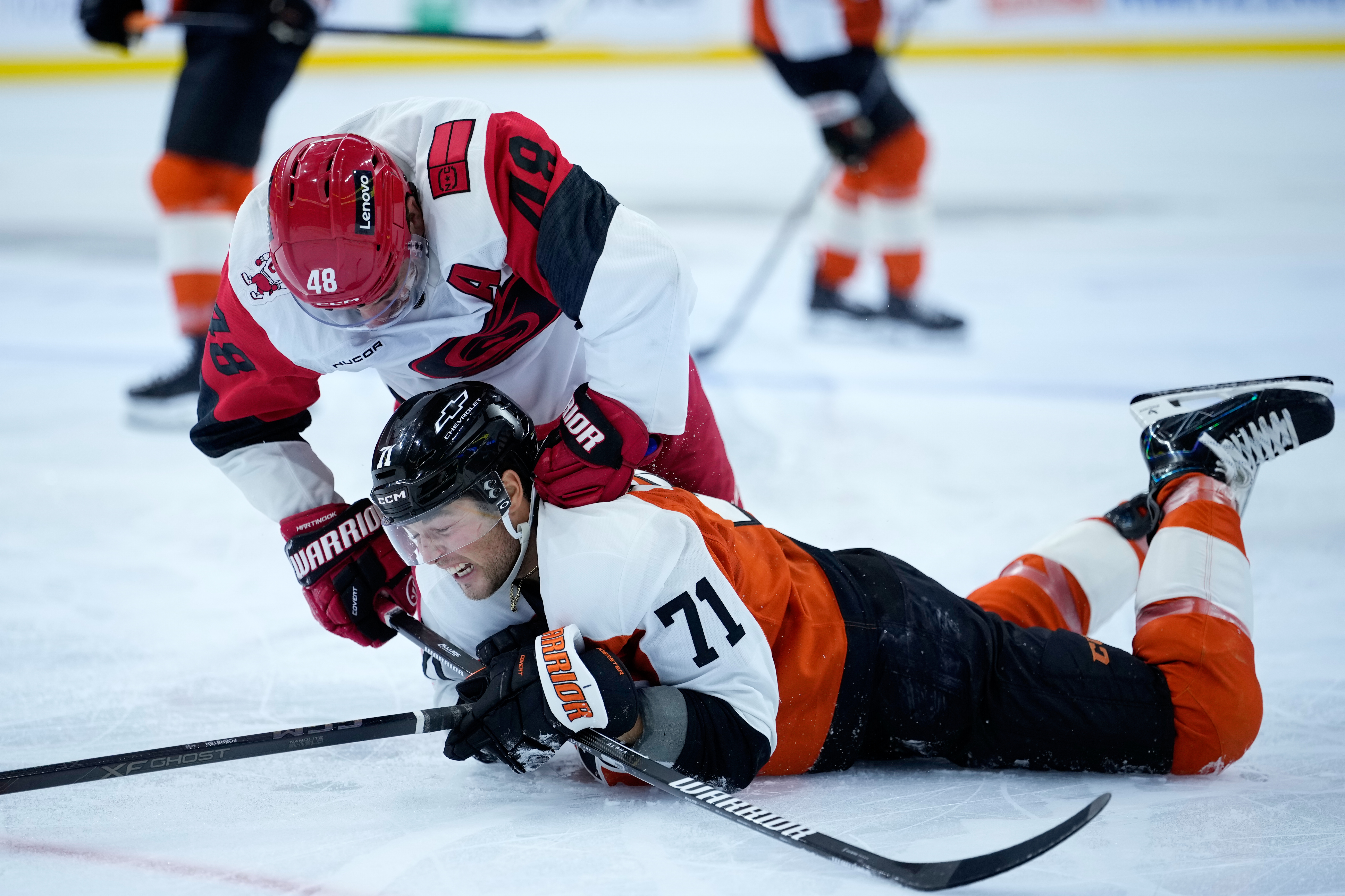 Carolina Hurricanes' Jordan Martinook, left, punches Philadelphia Flyers' Tyson Foerster during the second period of an NHL hockey game Sunday, Oct. 11, 2026, in Philadelphia.