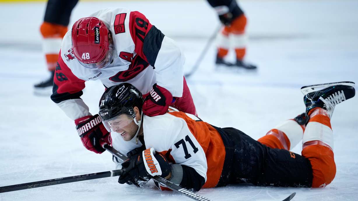 Carolina Hurricanes' Jordan Martinook, left, punches Philadelphia Flyers' Tyson Foerster during the second period of an NHL hockey game Sunday, Oct. 11, 2026, in Philadelphia.