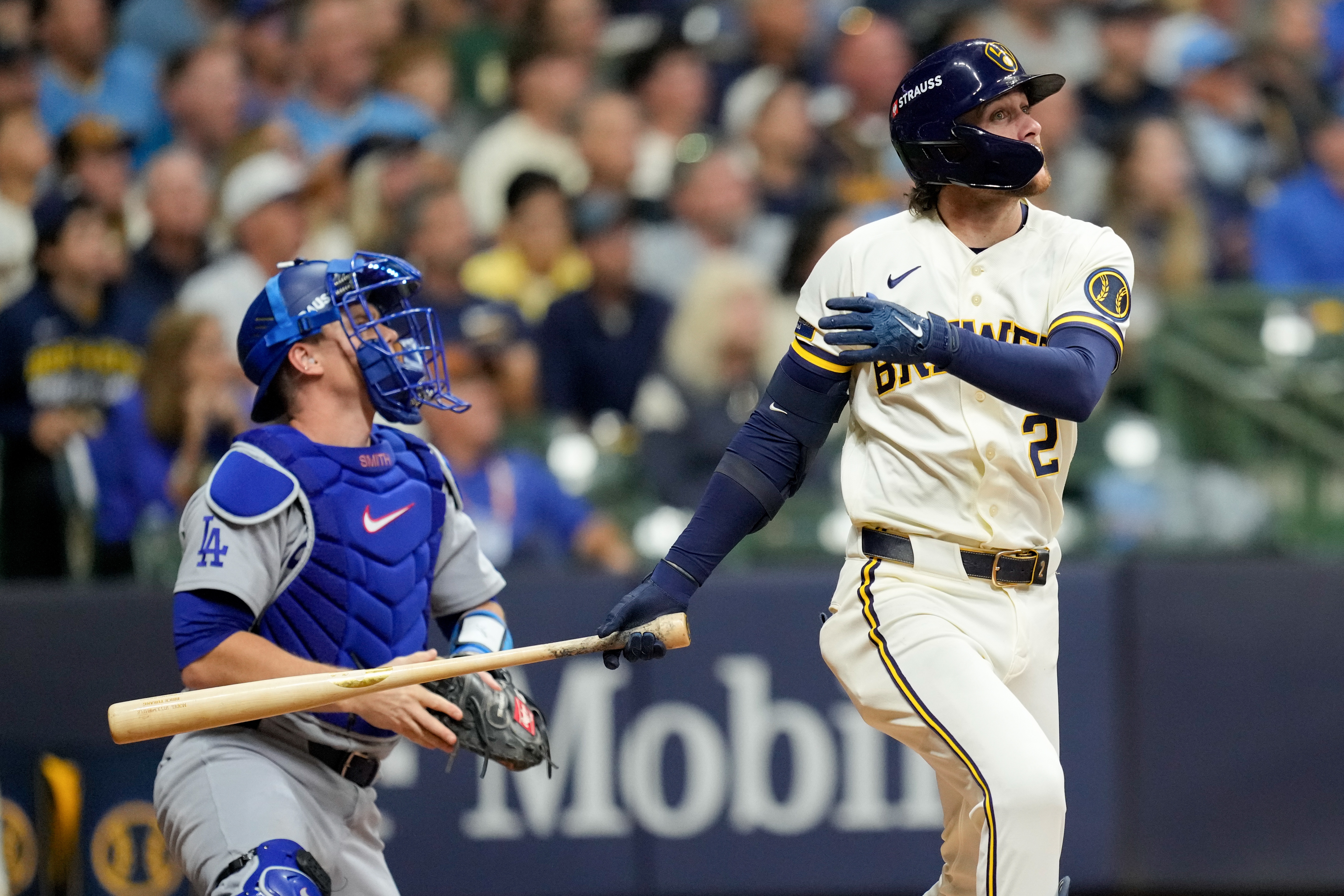 Milwaukee Brewers second baseman Brice Turang and Los Angeles Dodgers catcher Will Smith watch his solo home run take flight during the fourth inning of Game 1 of baseball's National League Championship Series between the Milwaukee Brewers and the Los Angeles Dodgers, Sunday, Oct. 11, 2026, in Milwaukee. 