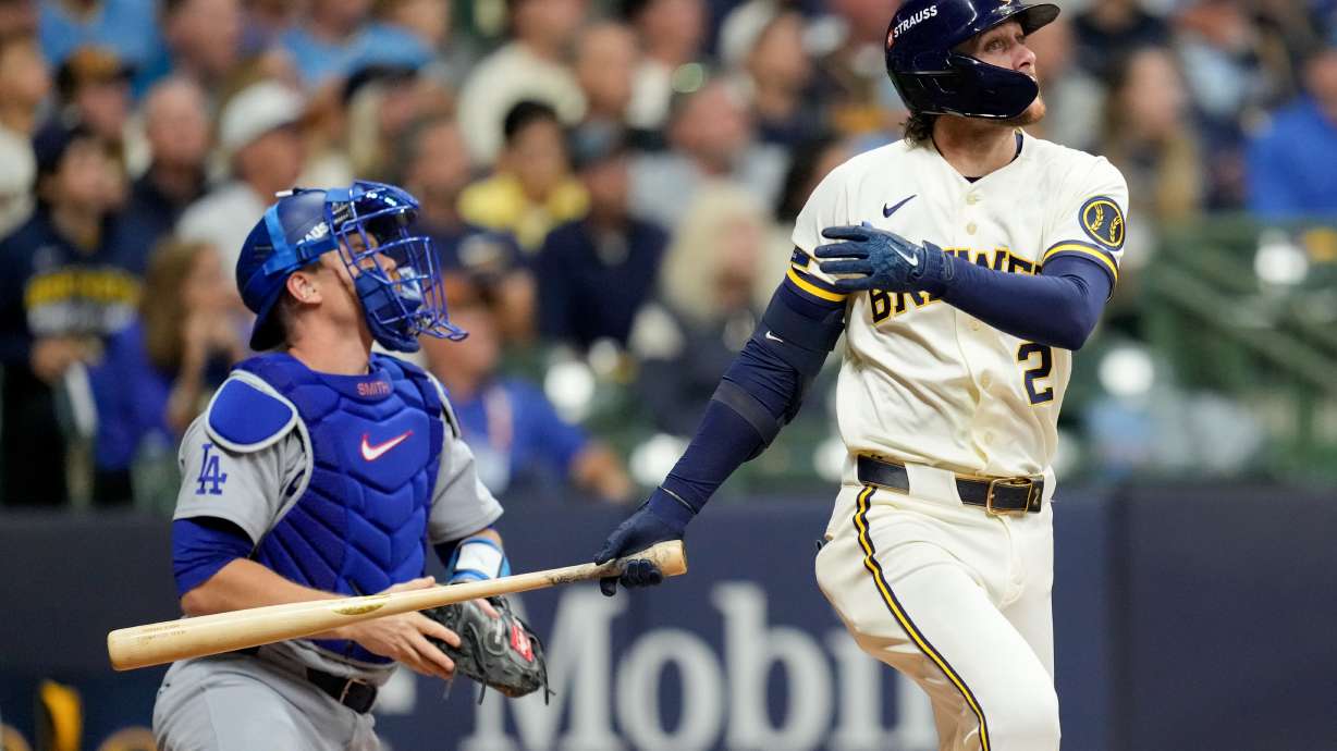 Milwaukee Brewers second baseman Brice Turang and Los Angeles Dodgers catcher Will Smith watch his solo home run take flight during the fourth inning of Game 1 of baseball's National League Championship Series between the Milwaukee Brewers and the Los Angeles Dodgers, Sunday, Oct. 11, 2026, in Milwaukee.