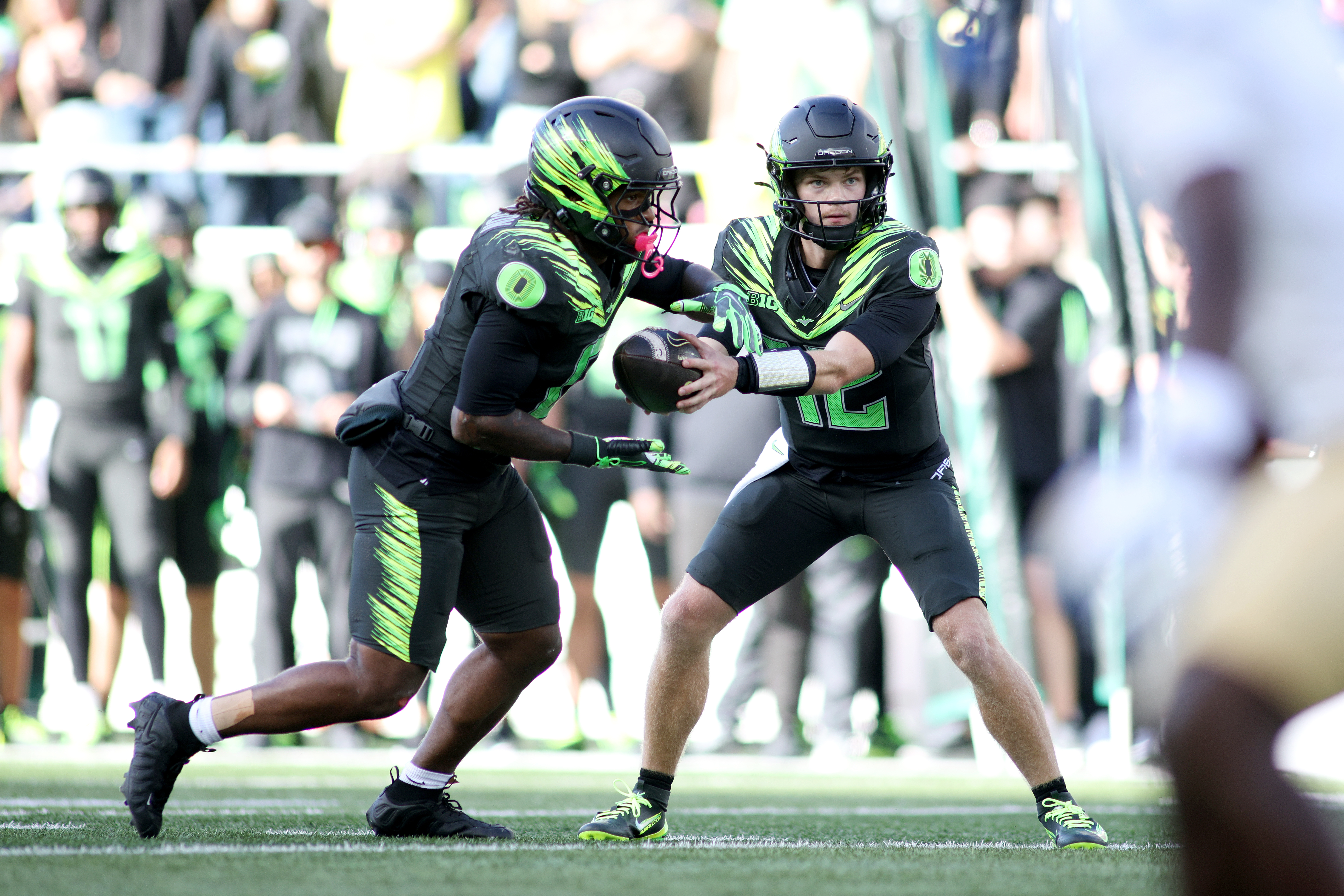 Oregon quarterback Brock Thomas (12) hands off the ball to running back Jordon Davison (0) during the second half of an NCAA college football game against UCLA, Saturday, Oct. 10, 2026, in Eugene, Ore. 