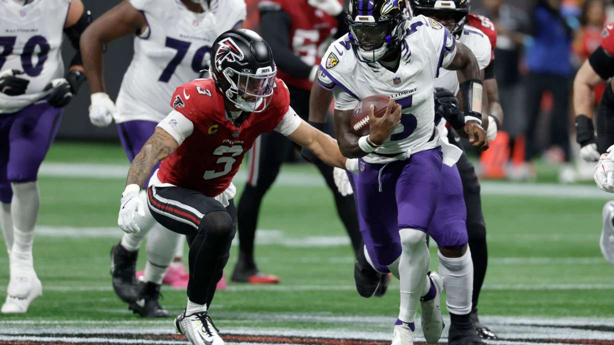 Baltimore Ravens quarterback Tyler Huntley (5) runs from Atlanta Falcons safety Jessie Bates III (3) during the first half of an NFL football game, Sunday, Oct. 11, 2026, in Atlanta.