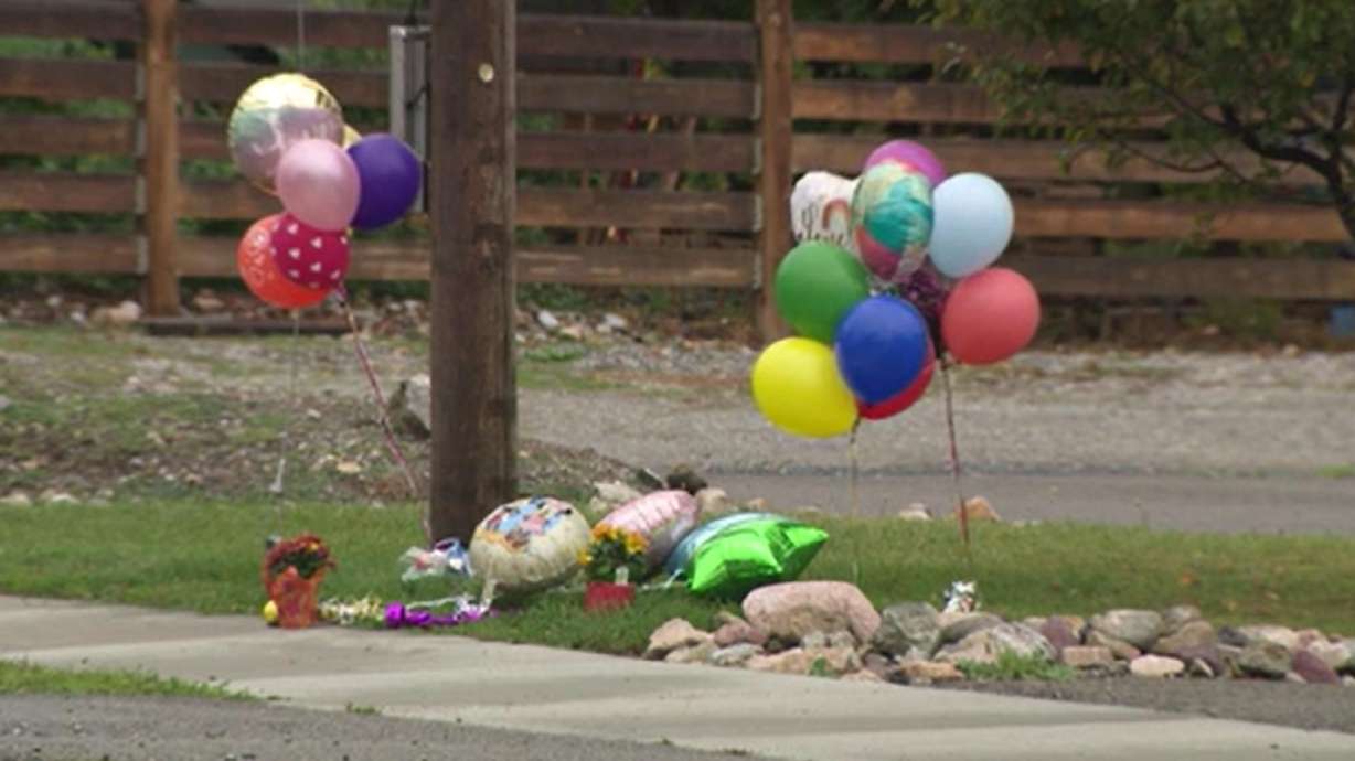 Flowers and balloons are pictured on Sunday outside of a home to memorialize the residents who passed away in Richmond.